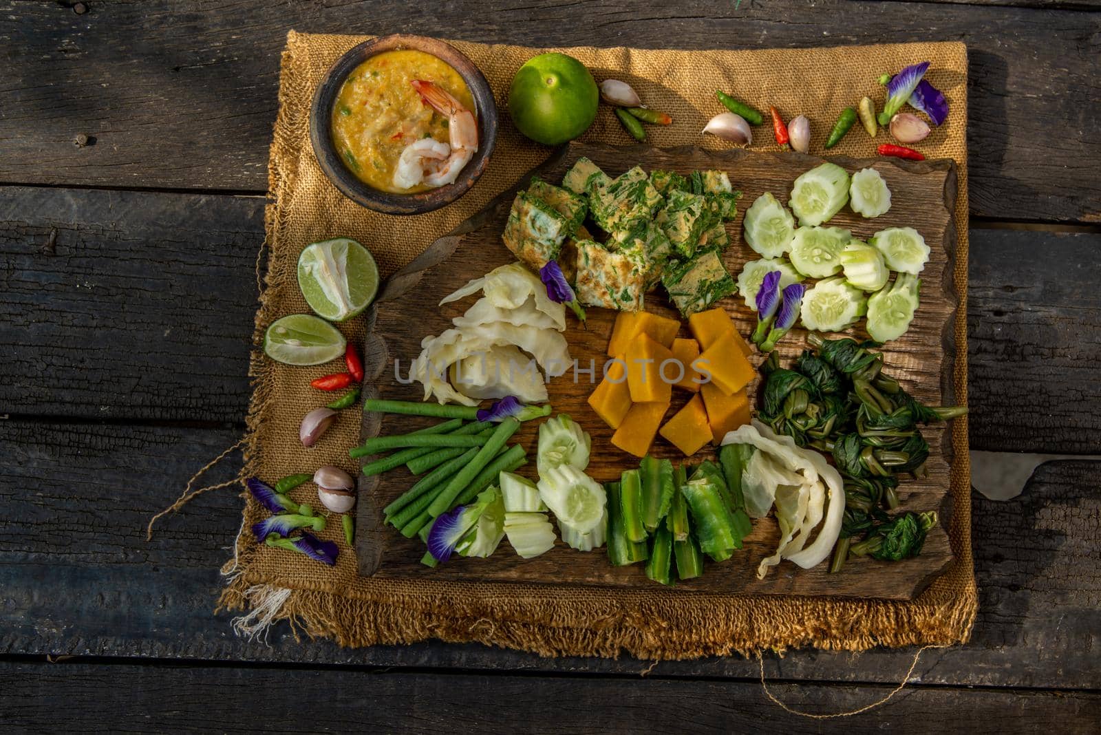 Thai Traditional Local Food : Shrimps chili dip or nam prik with shrimps (Nam Prik Goong Sod) with blanched vegetables and cha-om omelets on wooden backgroud.