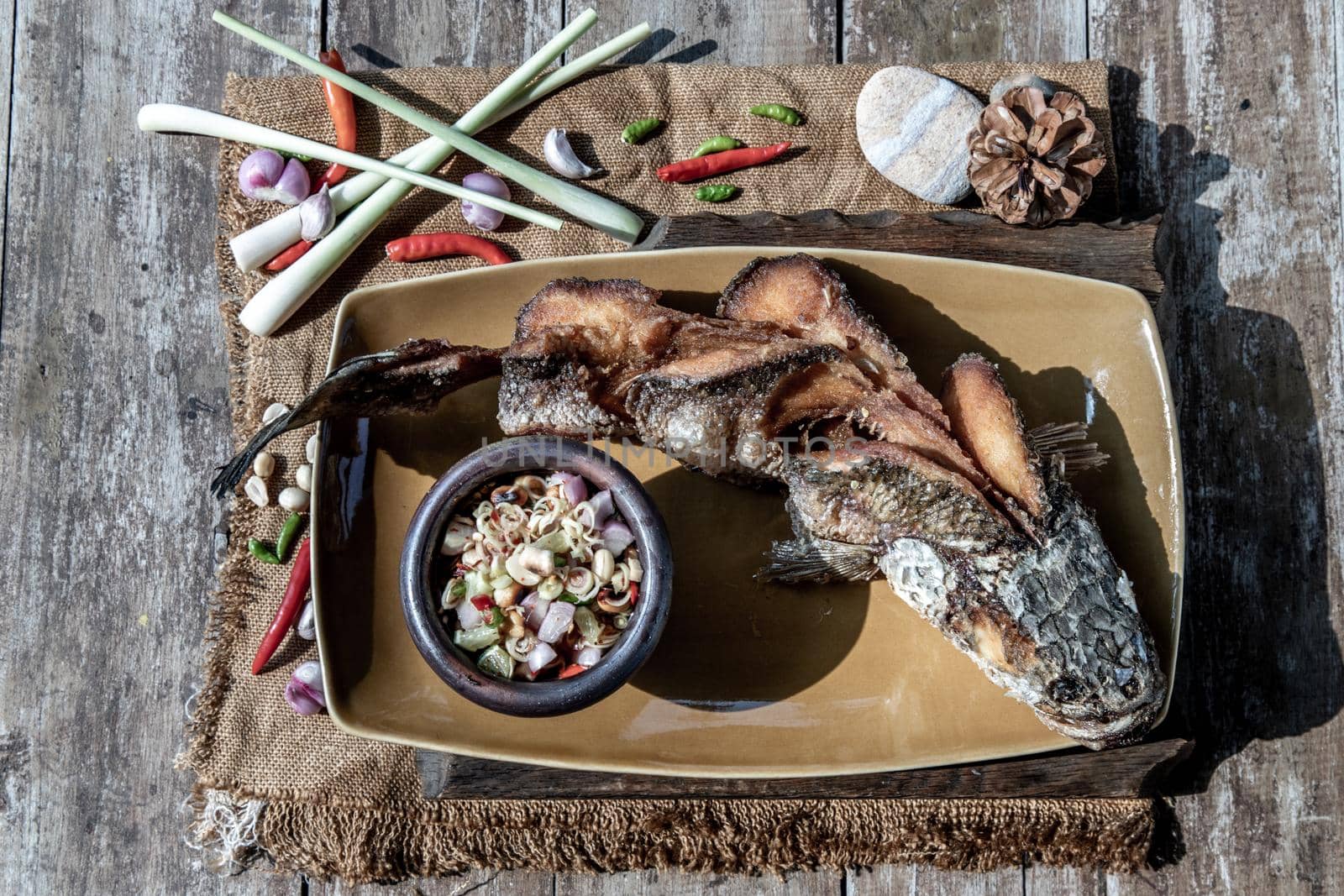 Deep fried whole Snakehead with spicy lemongrass salad, Thai food for health.