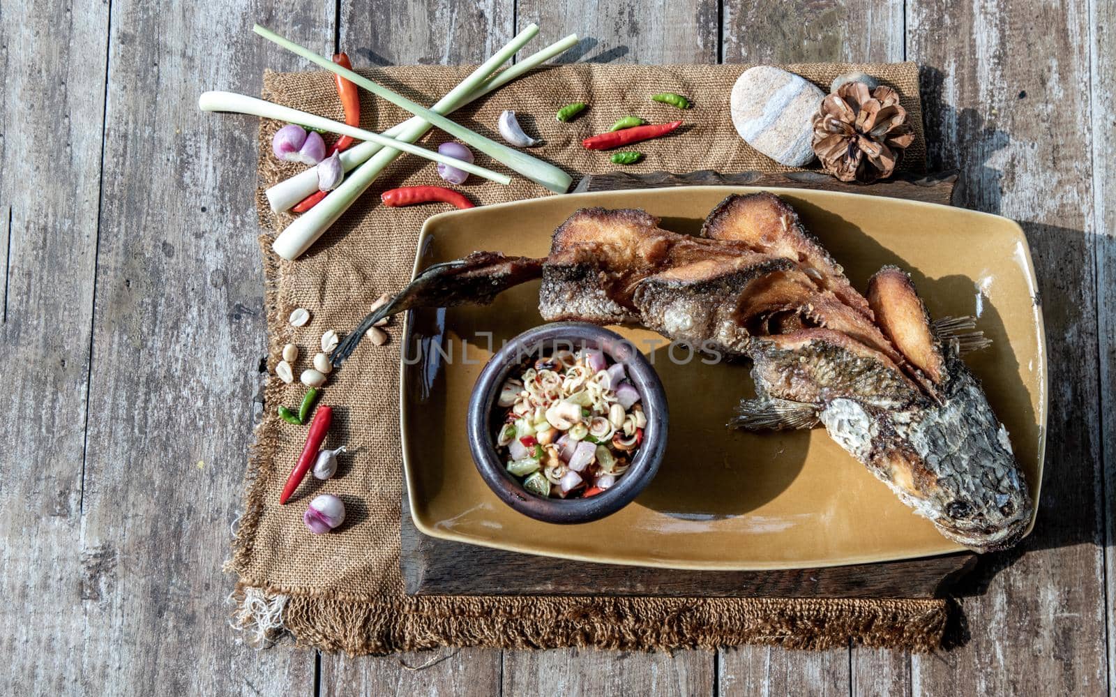 Deep fried whole Snakehead with spicy lemongrass salad, Thai food for health.
