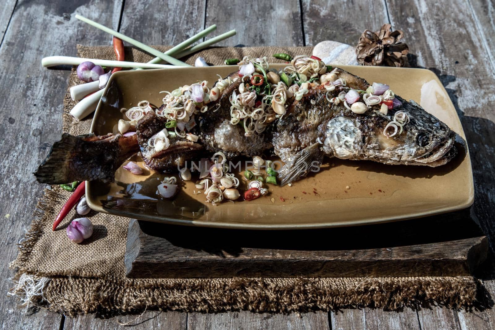 Deep fried whole Snakehead with spicy lemongrass salad, Thai food for health.