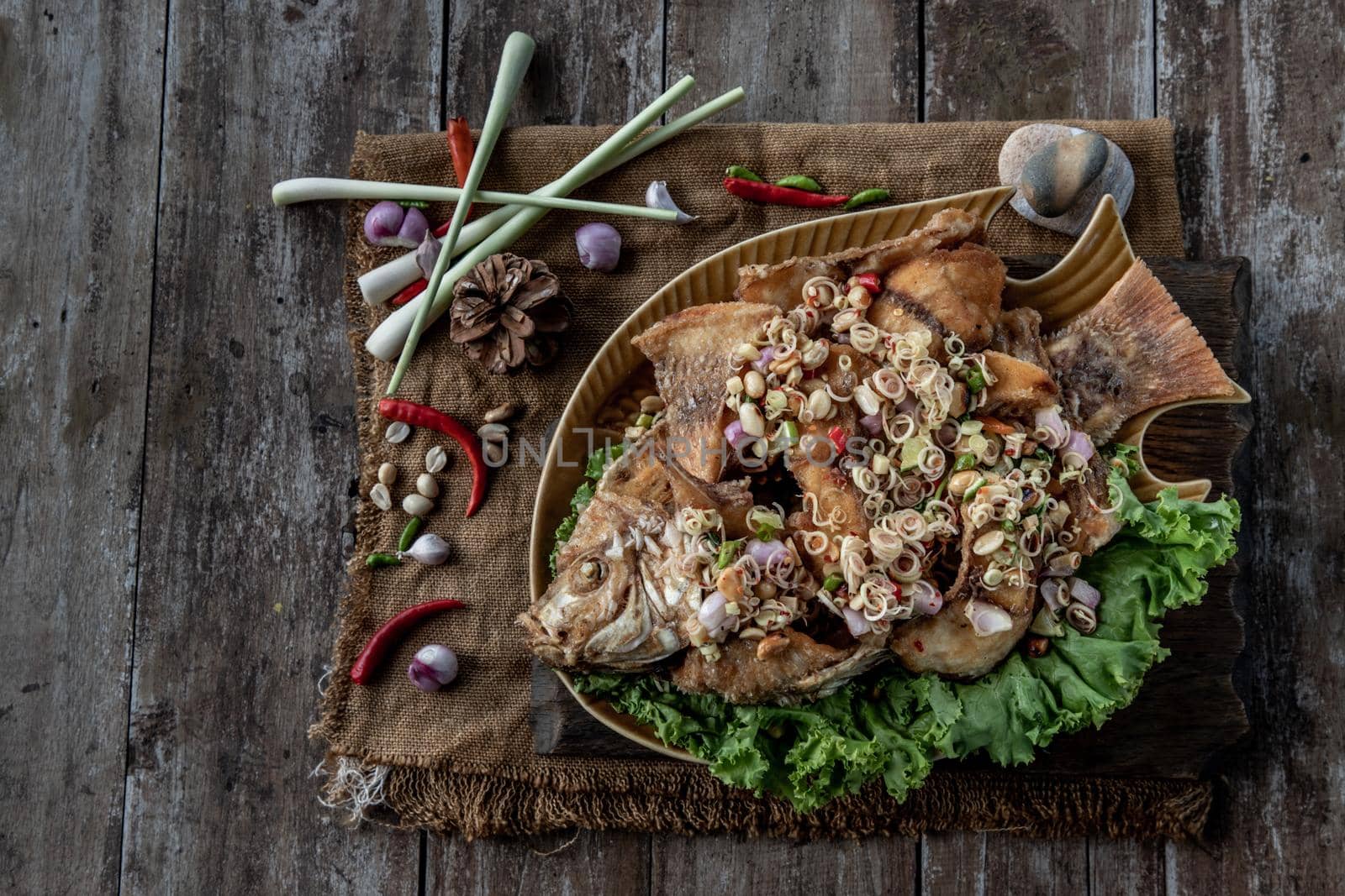 Deep fried whole Tubtim fish with spicy lemongrass salad, Thai food for health.