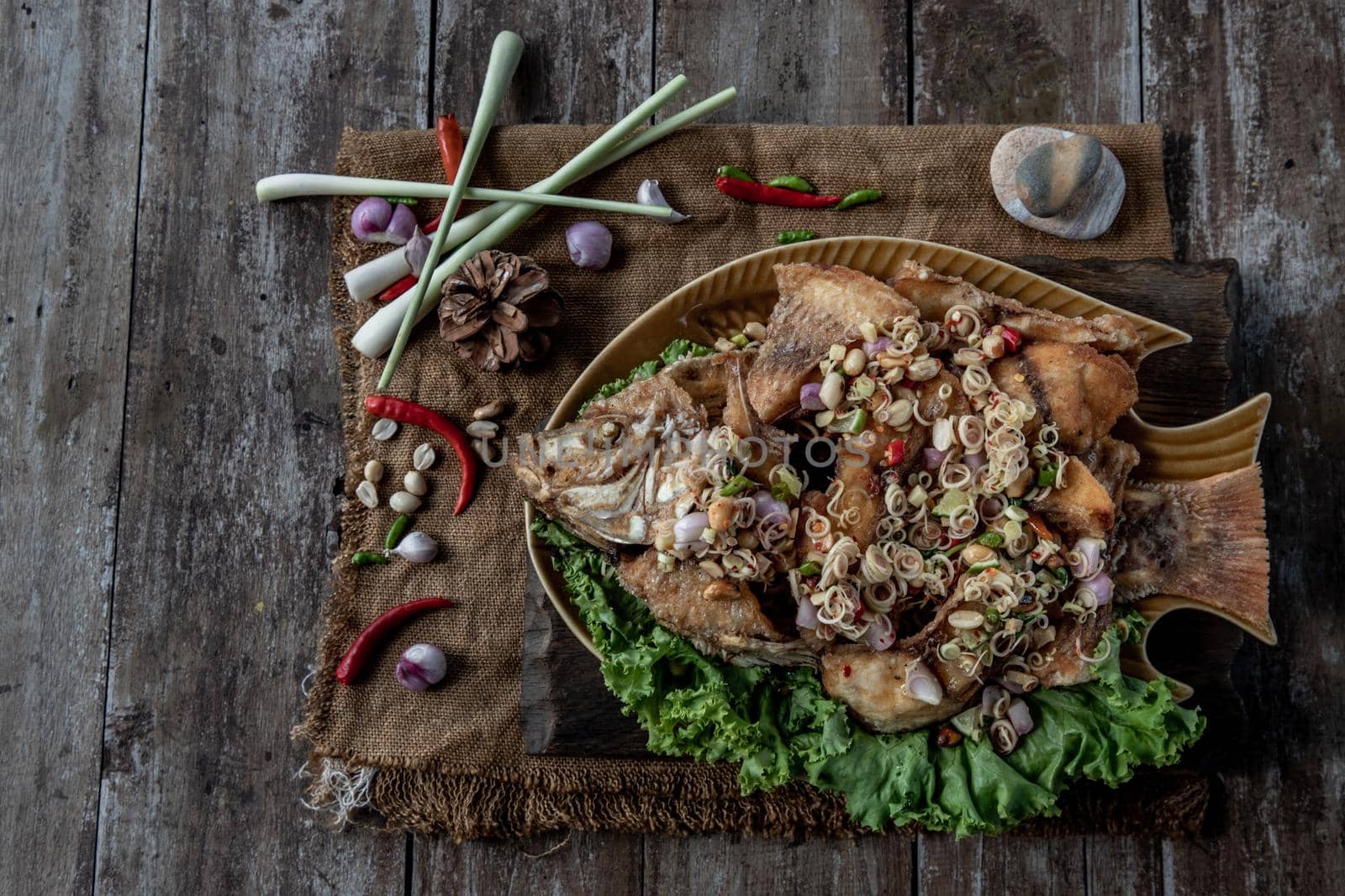 Deep fried whole Tubtim fish with spicy lemongrass salad, Thai food for health.