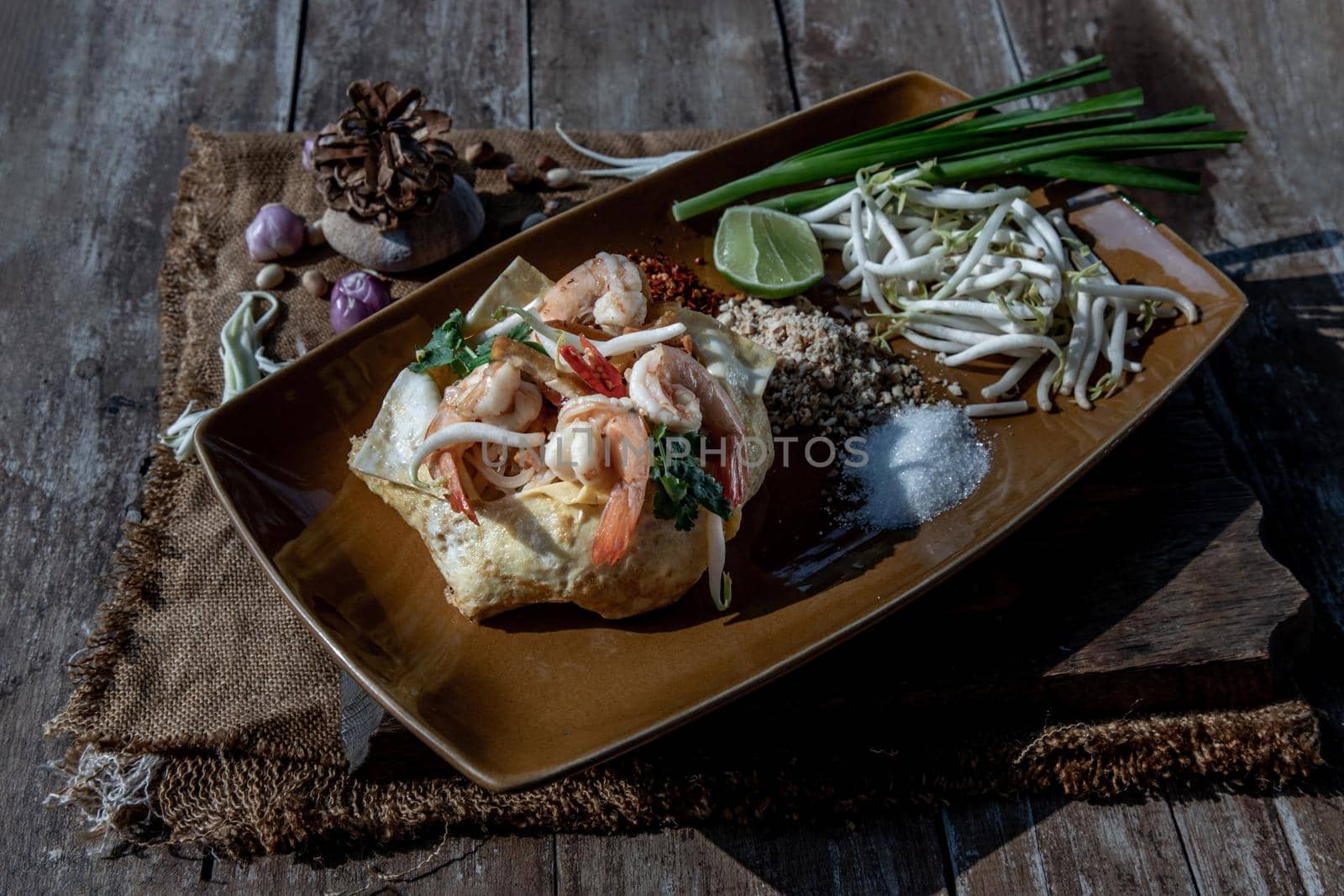 Fried Thai Noodle with Shrimp Wrapped in Egg (Pad Thai), That popular food for foreigner tourists, Oblique view from the top.