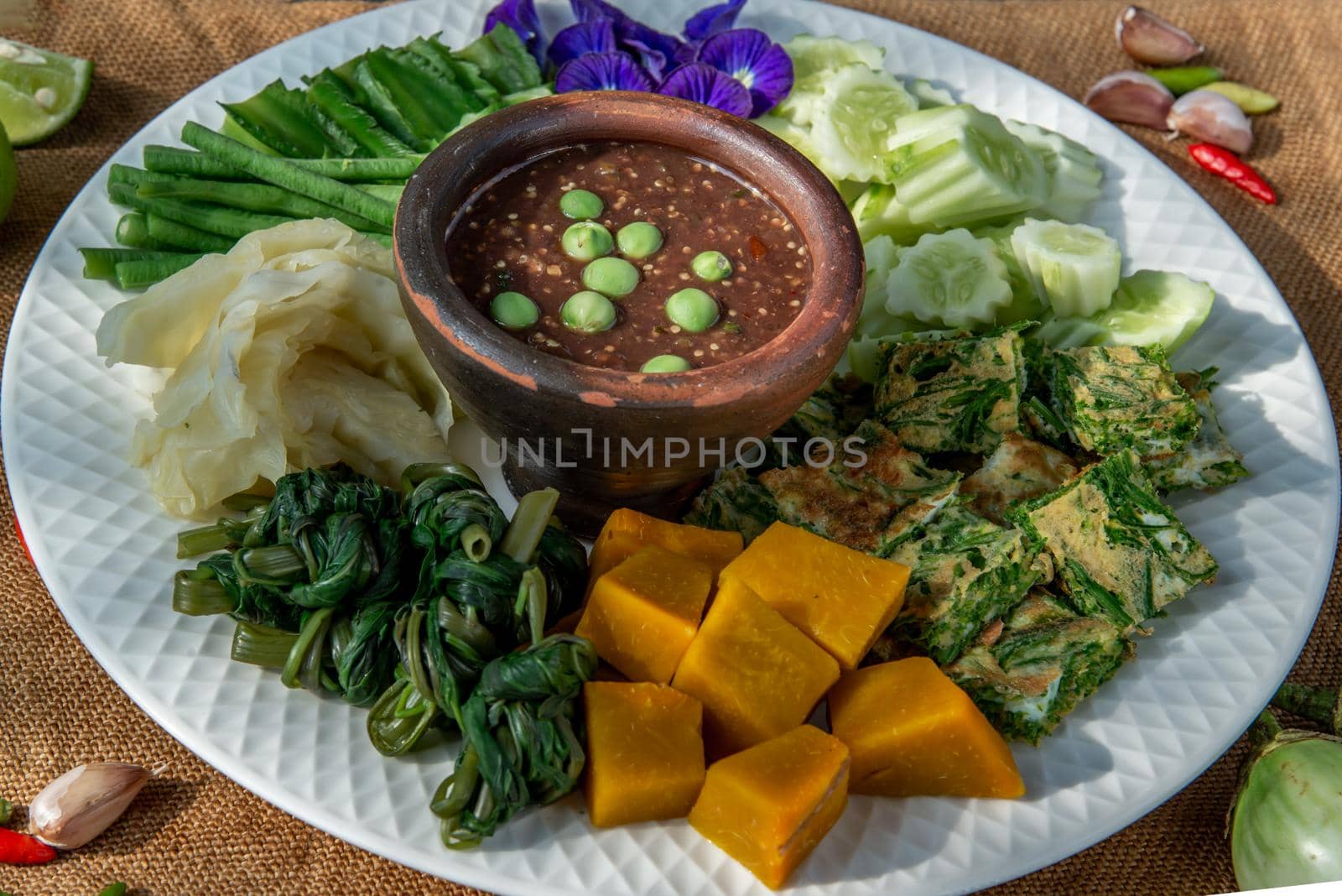 Thai Traditional Local Food : Spicy Shrimp Paste Dip or Fried shrimp paste sauce (Nam Prik Kapi) with blanched vegetables and cha-om omelets.