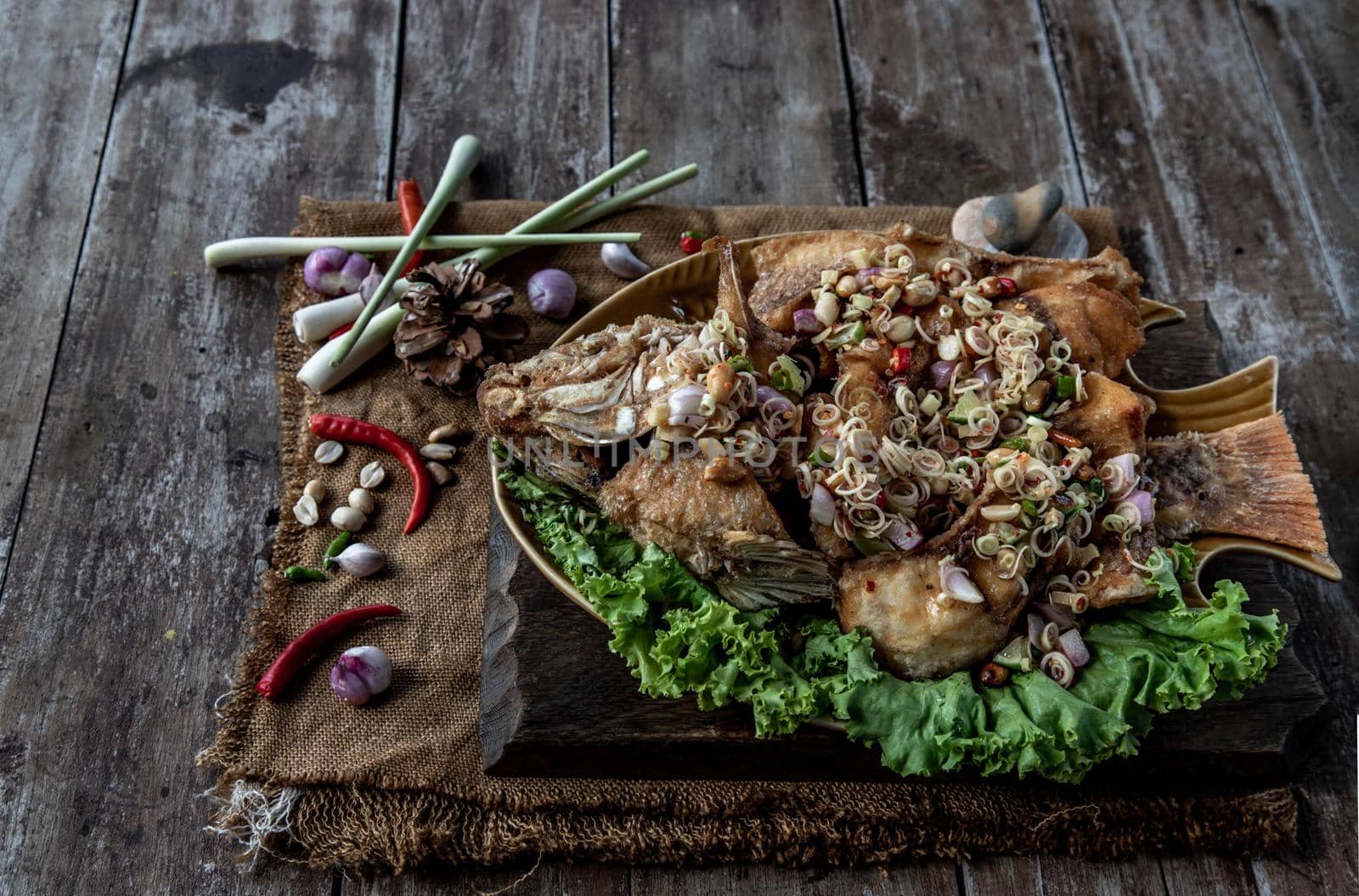 Deep fried whole Tubtim fish with spicy lemongrass salad, Thai food for health.
