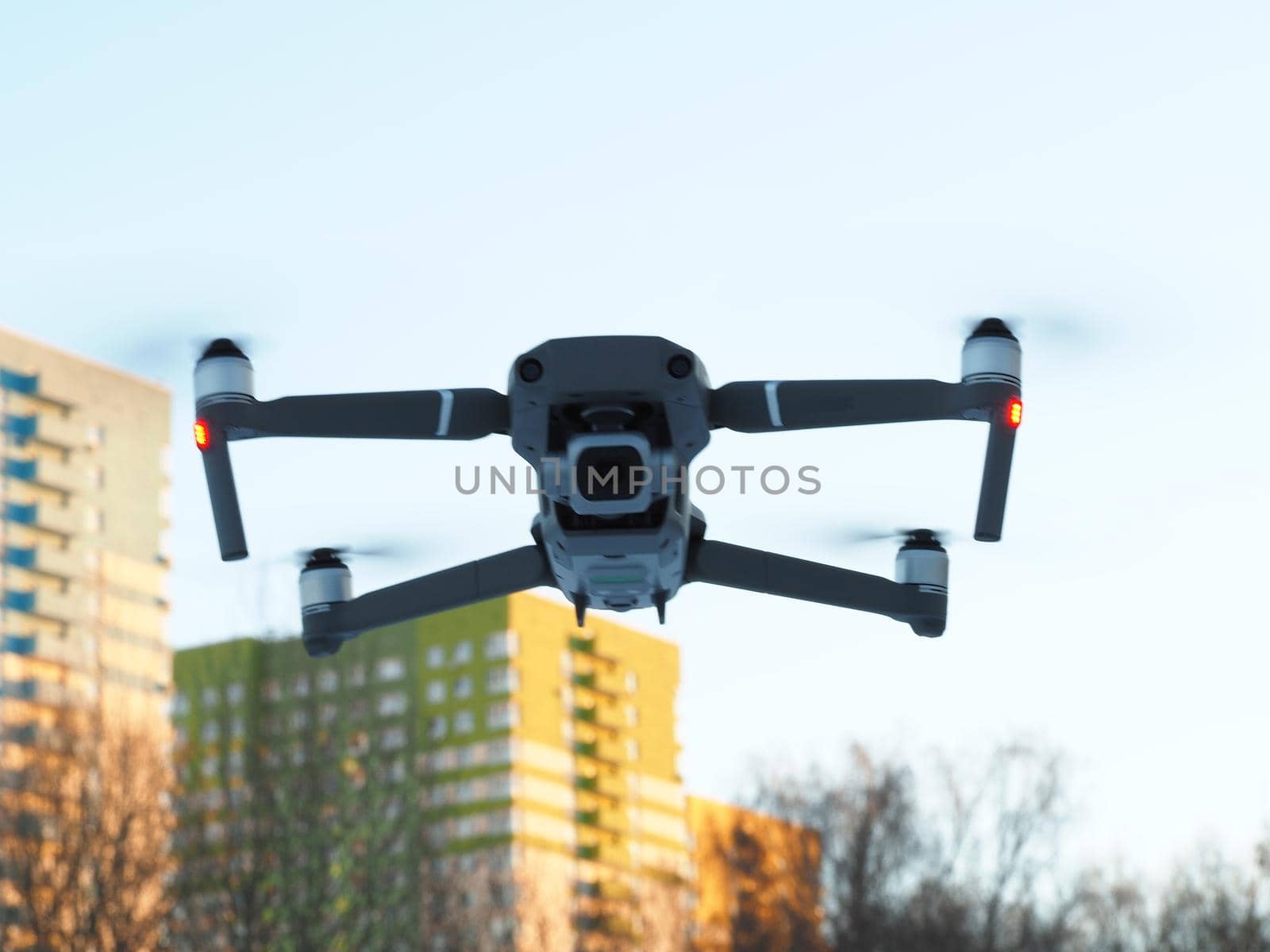 Grey drone, drone with camera flies in the air over the city. High quality photo