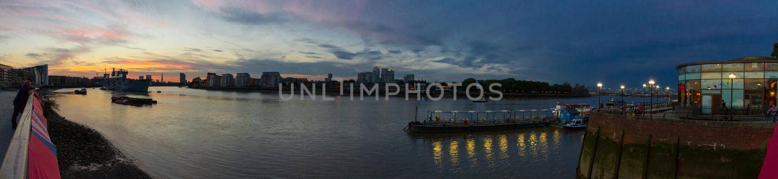 Panoramic view of Canary Wharf and the river Thames at sunset on a sunny summer evening