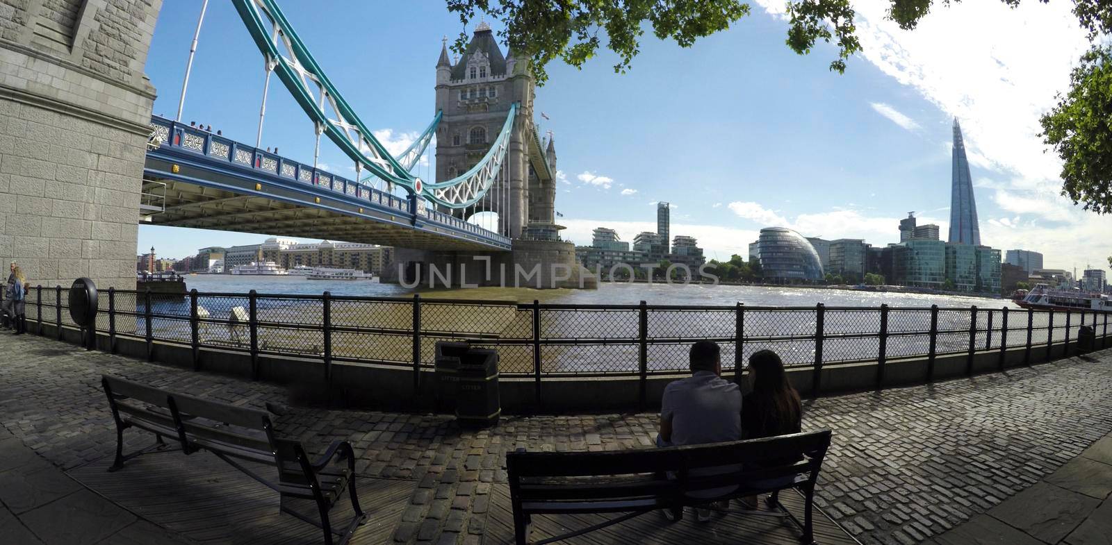 LONDON, UNITED KINGDOM - 27 June, 2017:  Tourist taking pictures of Tower Bridge at sunset in London, UK. by zefart