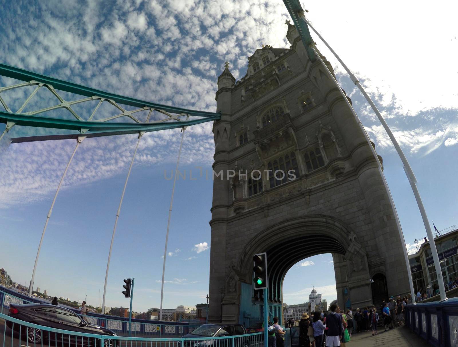 LONDON, ENGLAND- 29 June, 2017: Tourist POV Tourists and traffic on Tower Bridge on a sunny day. Tower Bridge is the most famous landmark of London. by zefart