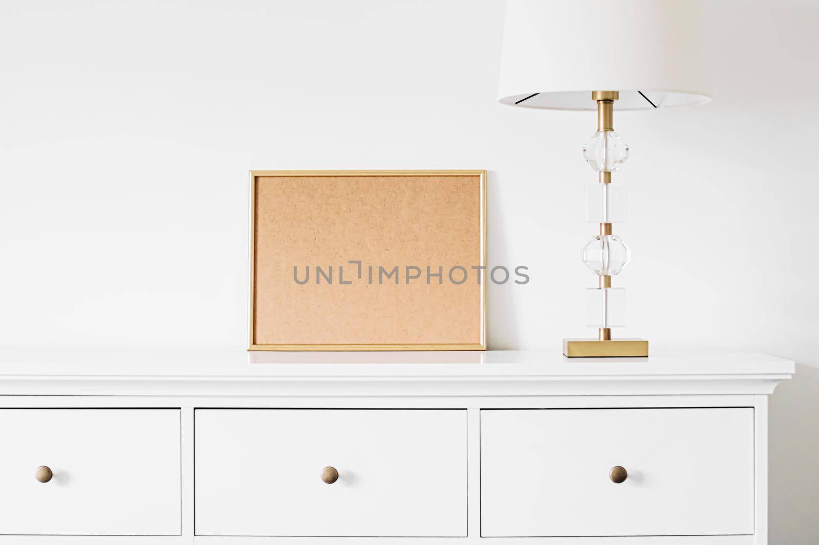 Golden horizontal frame for art, poster or photo in white interior, home decor concept