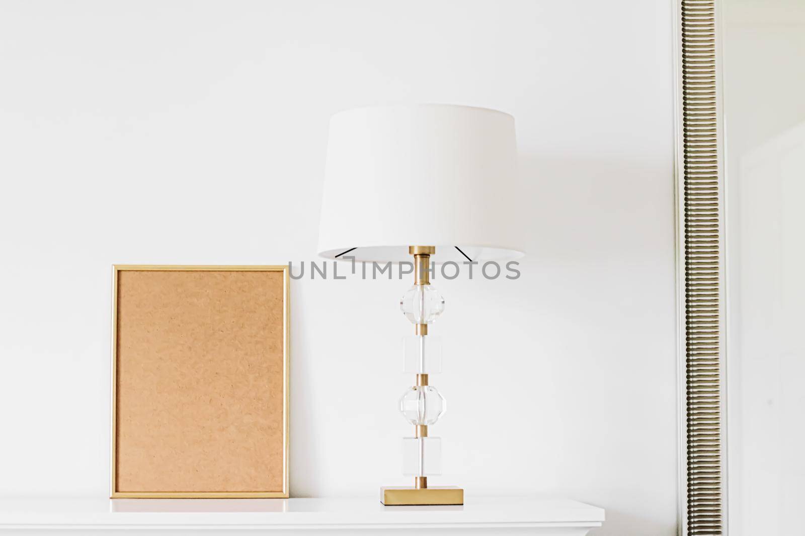 Golden vertical frame for art, poster or photo in white interior, home decor concept
