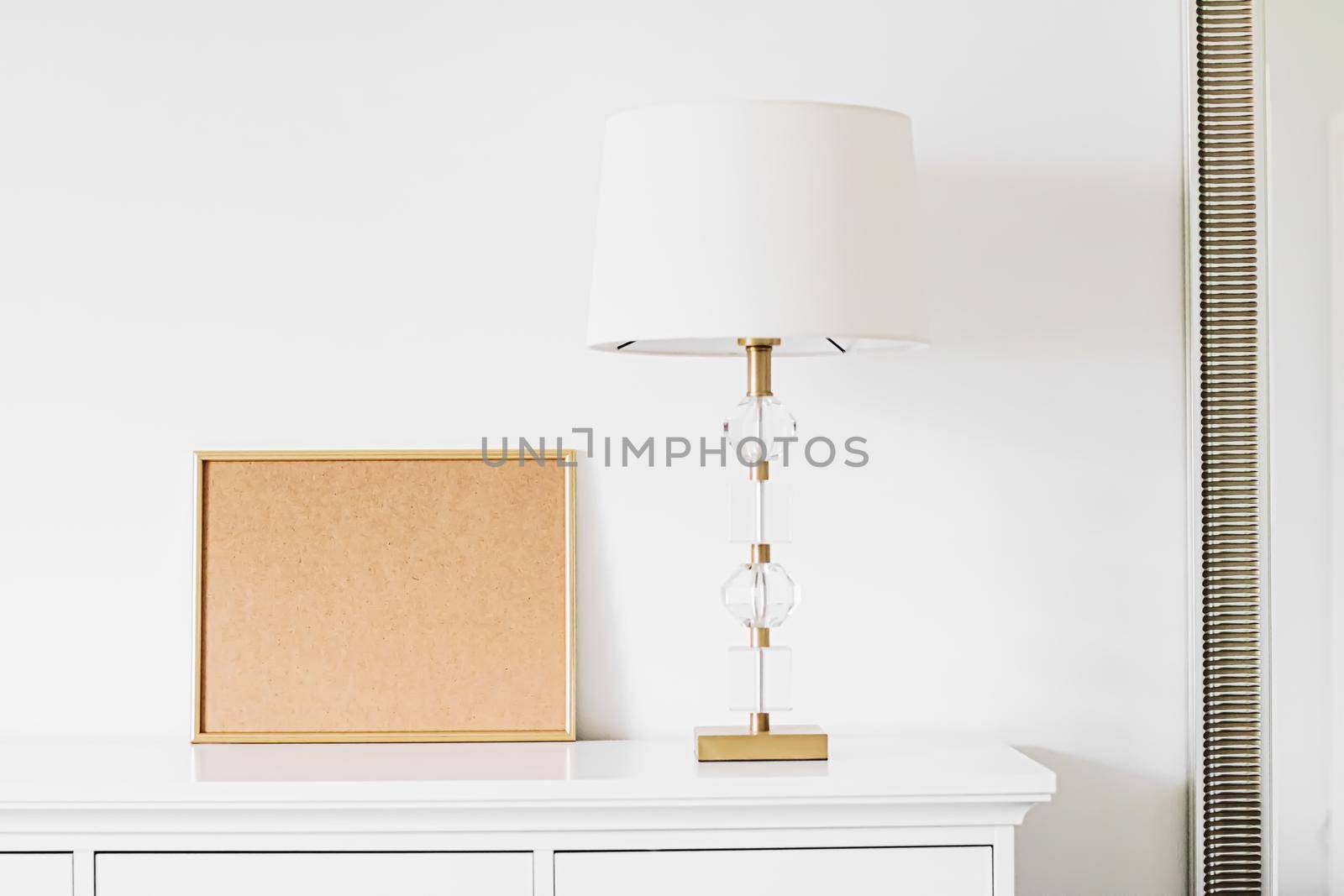 Golden horizontal frame for art, poster or photo in white interior, home decor concept