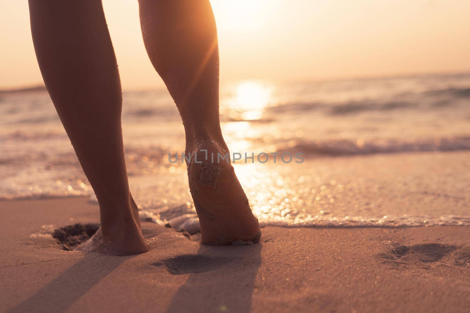 Woman feet walk slow life and relax on sand tropical beach with blue sky. by Suwant