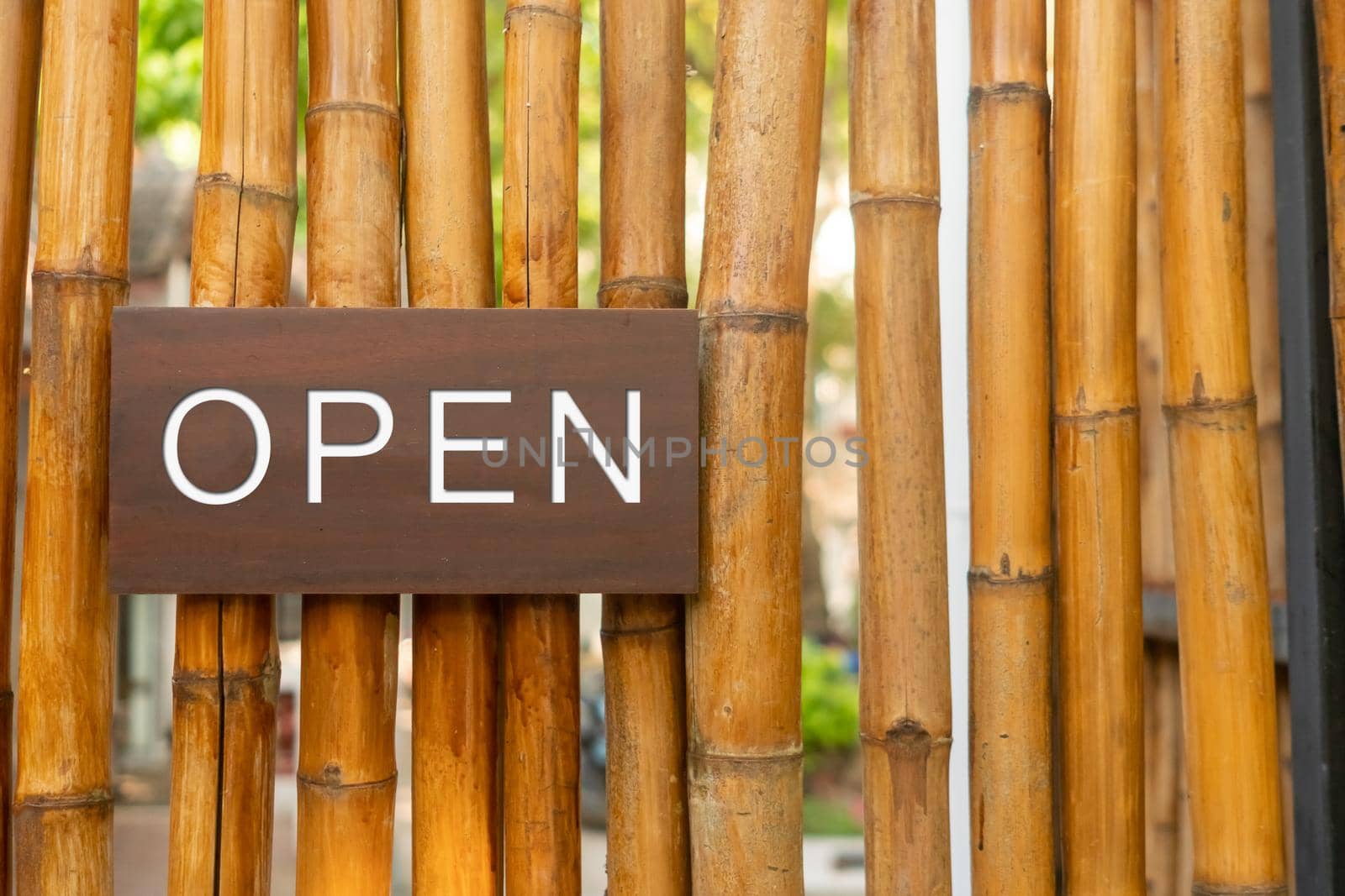 A business sign that says open on cafe or restaurant hang on door at entrance. by Suwant