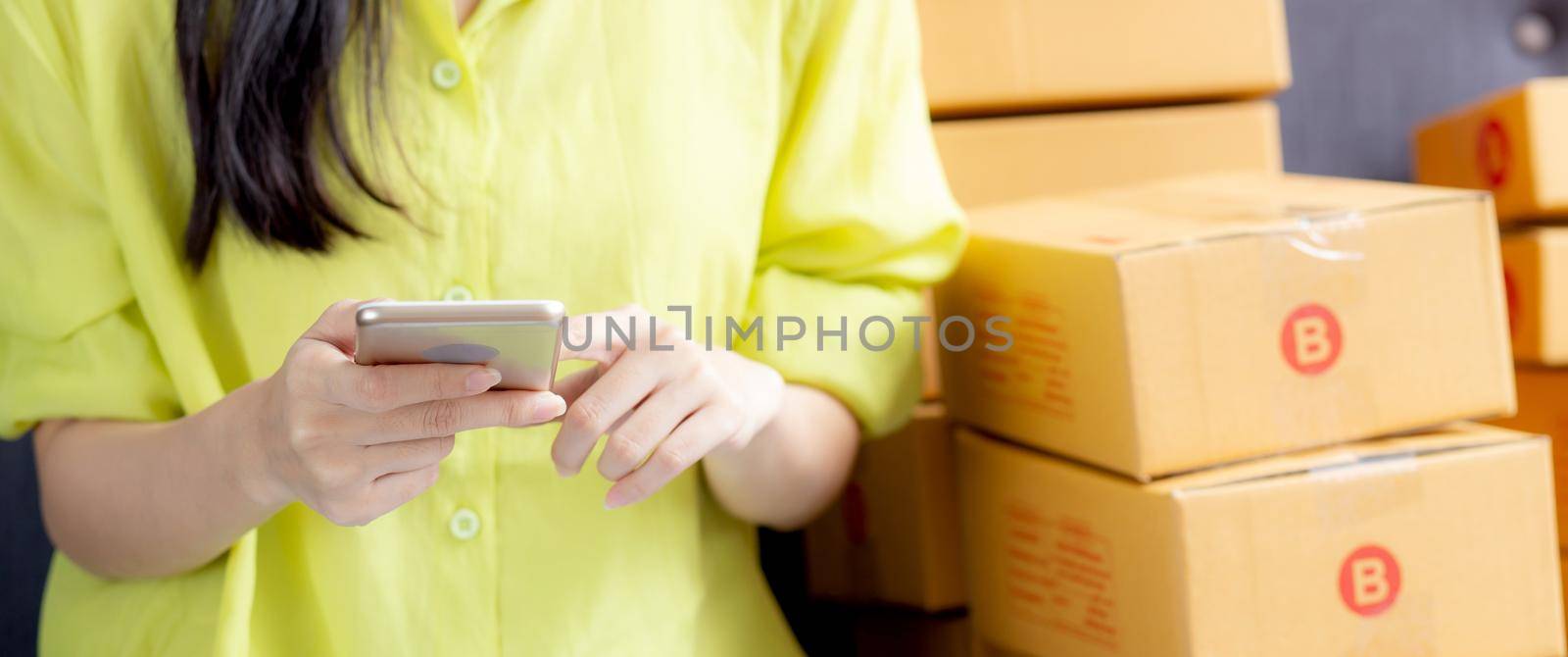 Closeup hand of young asian woman is entrepreneur check order from phone with customer while purchase online, logistic and delivery, online shopping, female is seller of business SME.