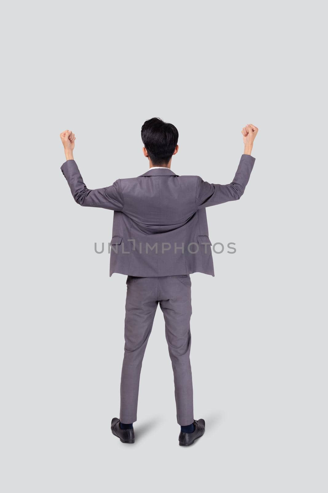 Portrait businessman in suit standing with win success isolated on white background, young asian business man is manager or executive having confident and excited, expression and emotion, back view. by nnudoo