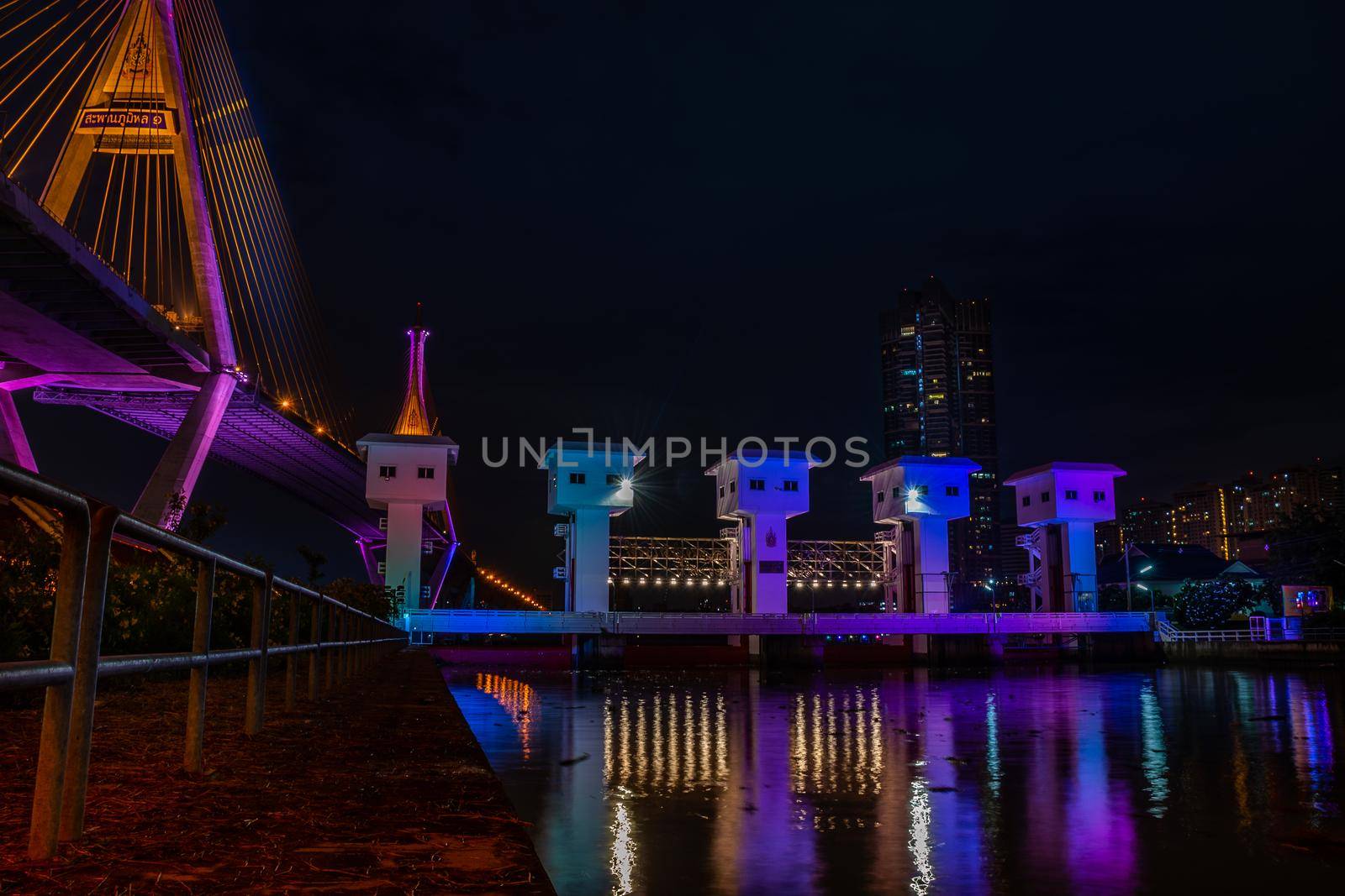 Samutprakan, thailand -  jun, 2019 : Bhumibol Bridge also casually call as Industrial Ring Road Bridge with floodgate illuminate with spotlight at night scene, Samut Prakarn, Thailand
