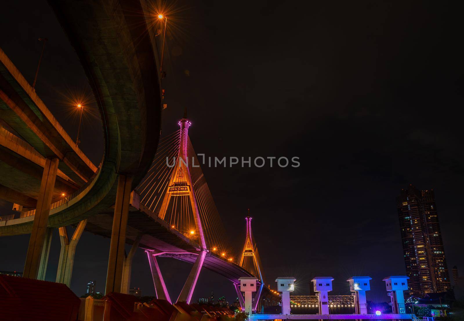 Samutprakan, thailand -  jun, 2019 : Bhumibol Bridge also casually call as Industrial Ring Road Bridge with floodgate illuminate with spotlight at night scene, Samut Prakarn, Thailand