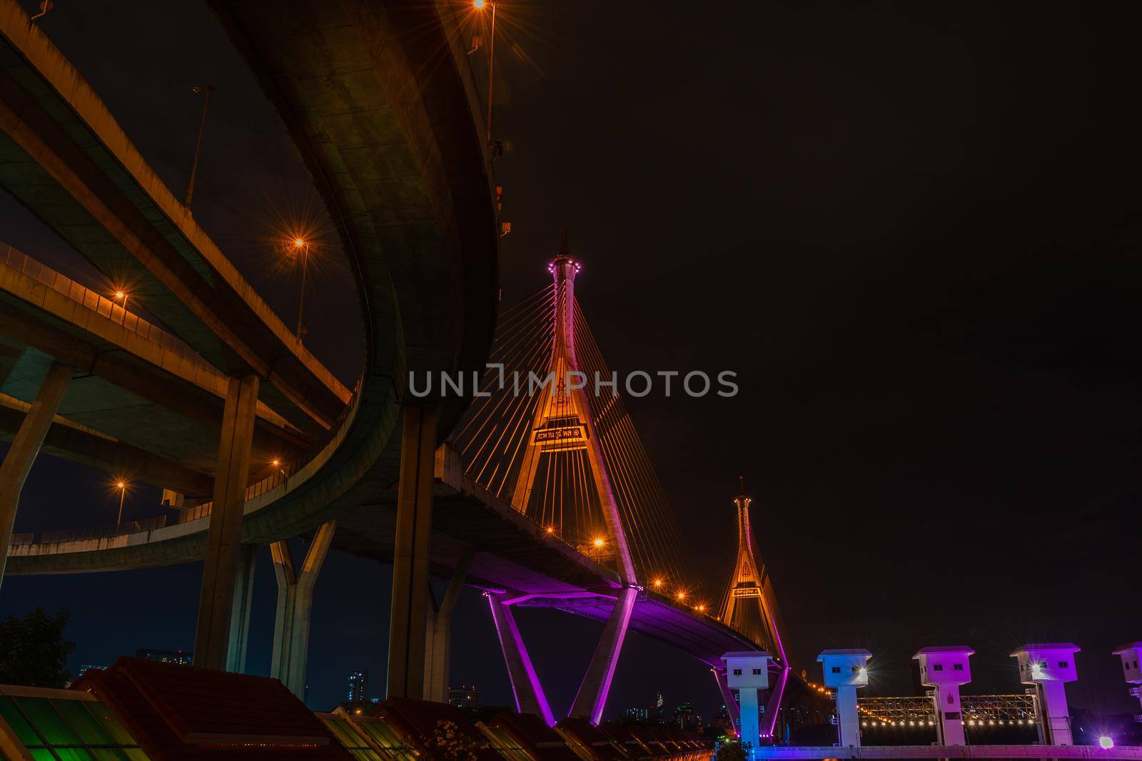 Samutprakan, thailand -  jun, 2019 : Bhumibol Bridge also casually call as Industrial Ring Road Bridge with floodgate illuminate with spotlight at night scene, Samut Prakarn, Thailand