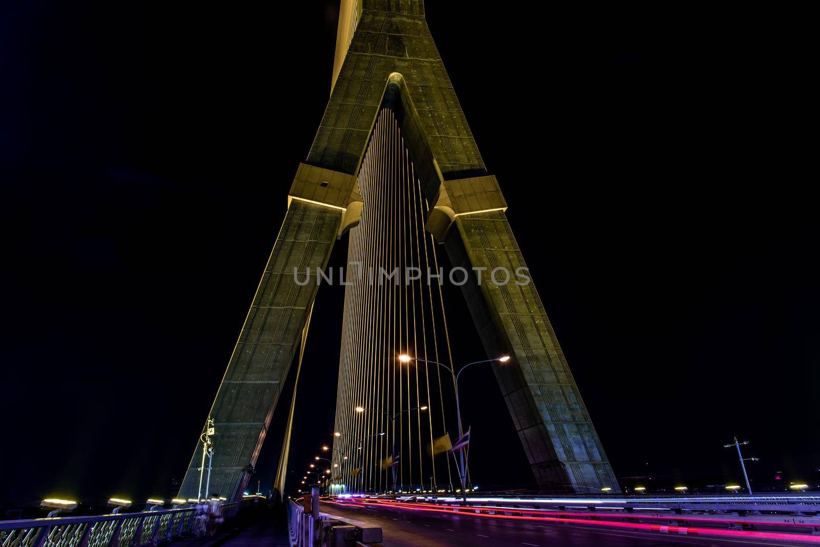 Bangkok, thailand - Nov 23, 2019 : Night sky at road on Rama VIII Bridge with car trails at twilight time in Bangkok, Thailand
