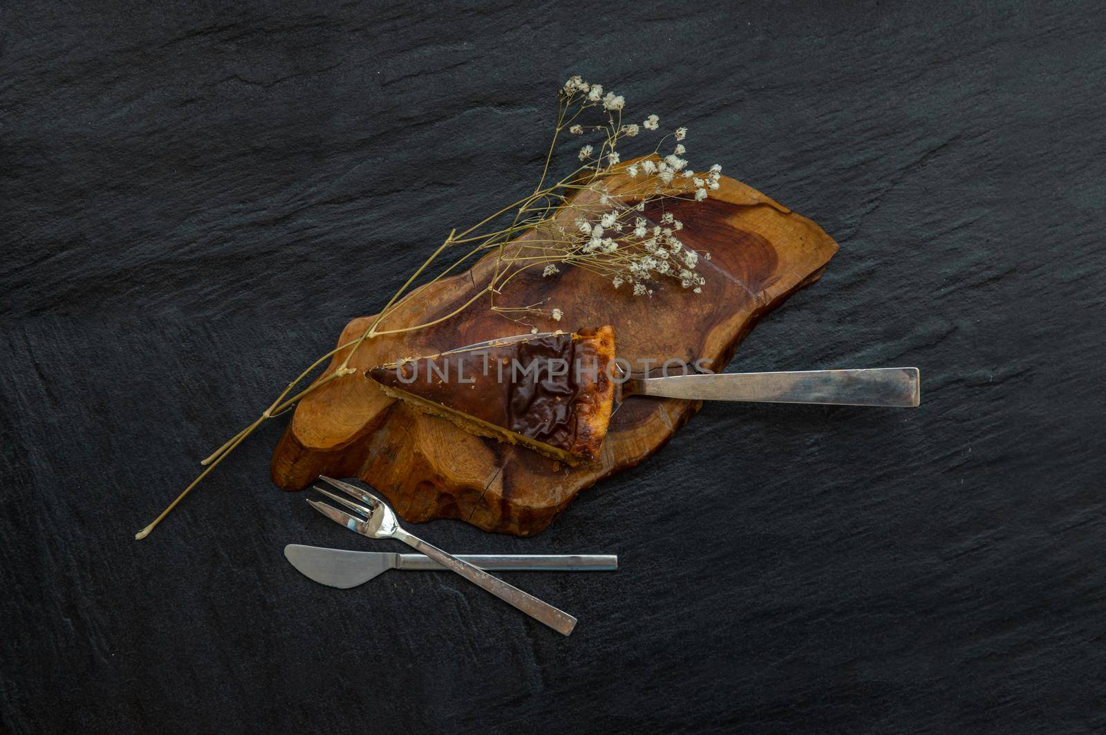 Slice of delicious fresh Tartellette creme brulee a la vanille on a wooden plate. Top view.
