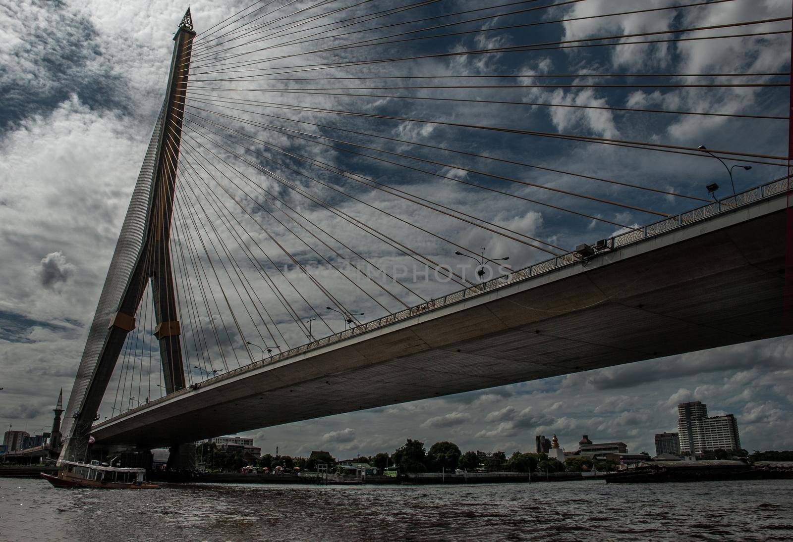 Bangkok, thailand 21 Jul, 2019 : Rama Rama VIII bridge, Rope Bridge across the Chao Phraya River, A tall V-shape pylon tower with view blue sky is background and Cityscape of Bangkok.