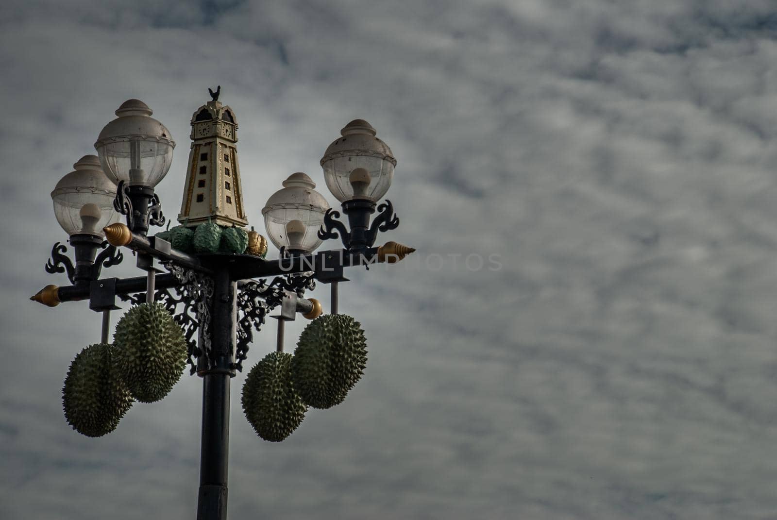 Nonthaburi, Thailand - 21 Jul 2019 : Street lamp in front of the Chinese shrine decorated with durian balls and has a background of blue sky and white clouds. Space for messages.