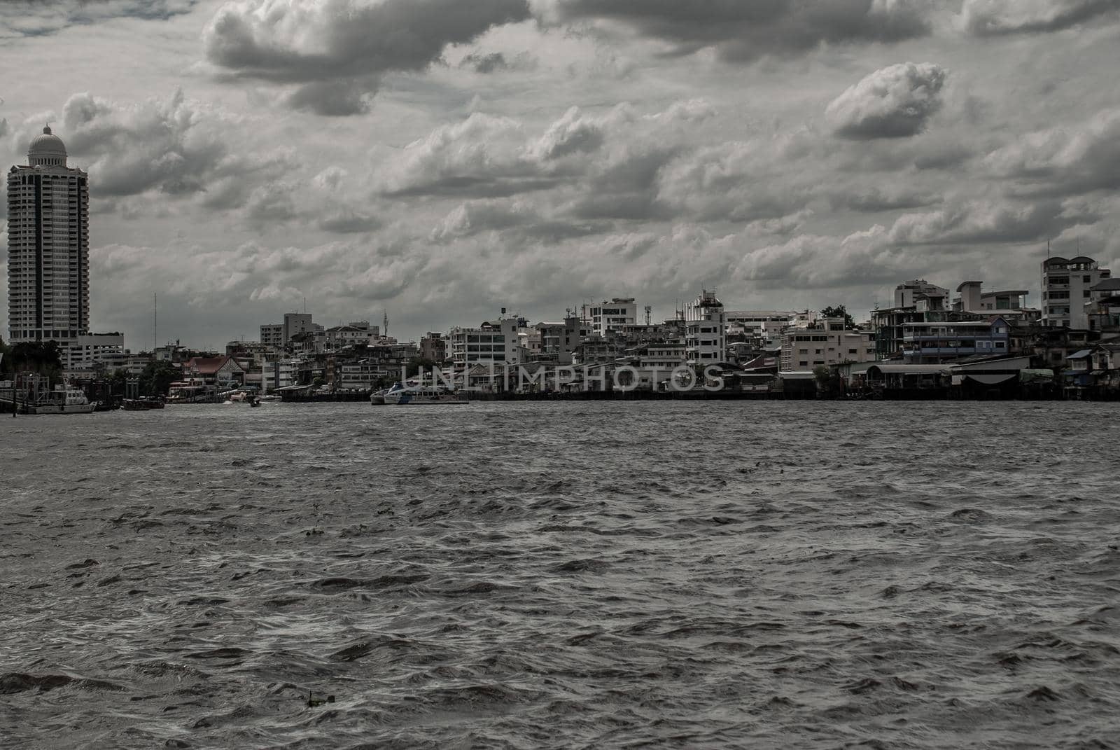 Bangkok, Thailand - 21 Jul 2019 : A view of the bank of Bangkok's Chao Phraya River showing the several tall buildings in the beautiful skyline.