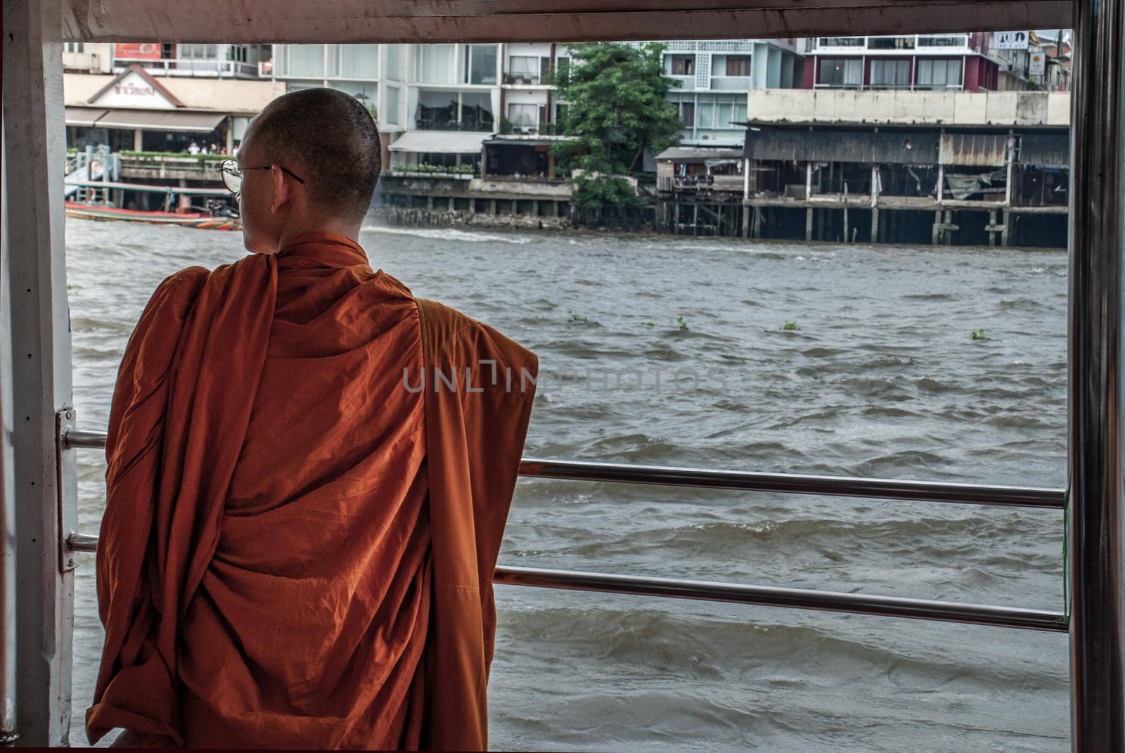 Bangkok, thailand 21 Jul, 2019 : The monks stood on the Chao Phraya Express Boat to travel by water to the temple.