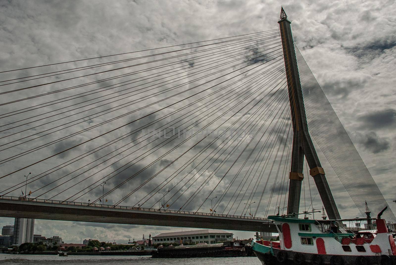 Bangkok, thailand 21 Jul, 2019 : Rama VIII bridge, Rope Bridge across the Chao Phraya River, A tall V-shape pylon tower with view blue sky is background, Cloudy day.