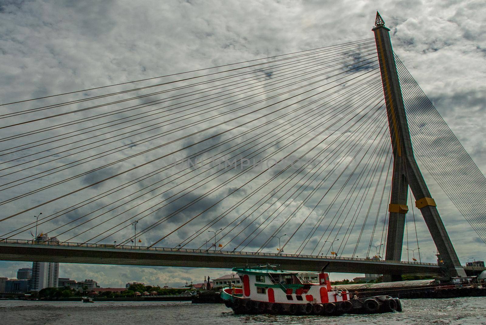 Bangkok, thailand 21 Jul, 2019 : Rama VIII bridge, Rope Bridge across the Chao Phraya River, A tall V-shape pylon tower with view blue sky is background, Cloudy day.