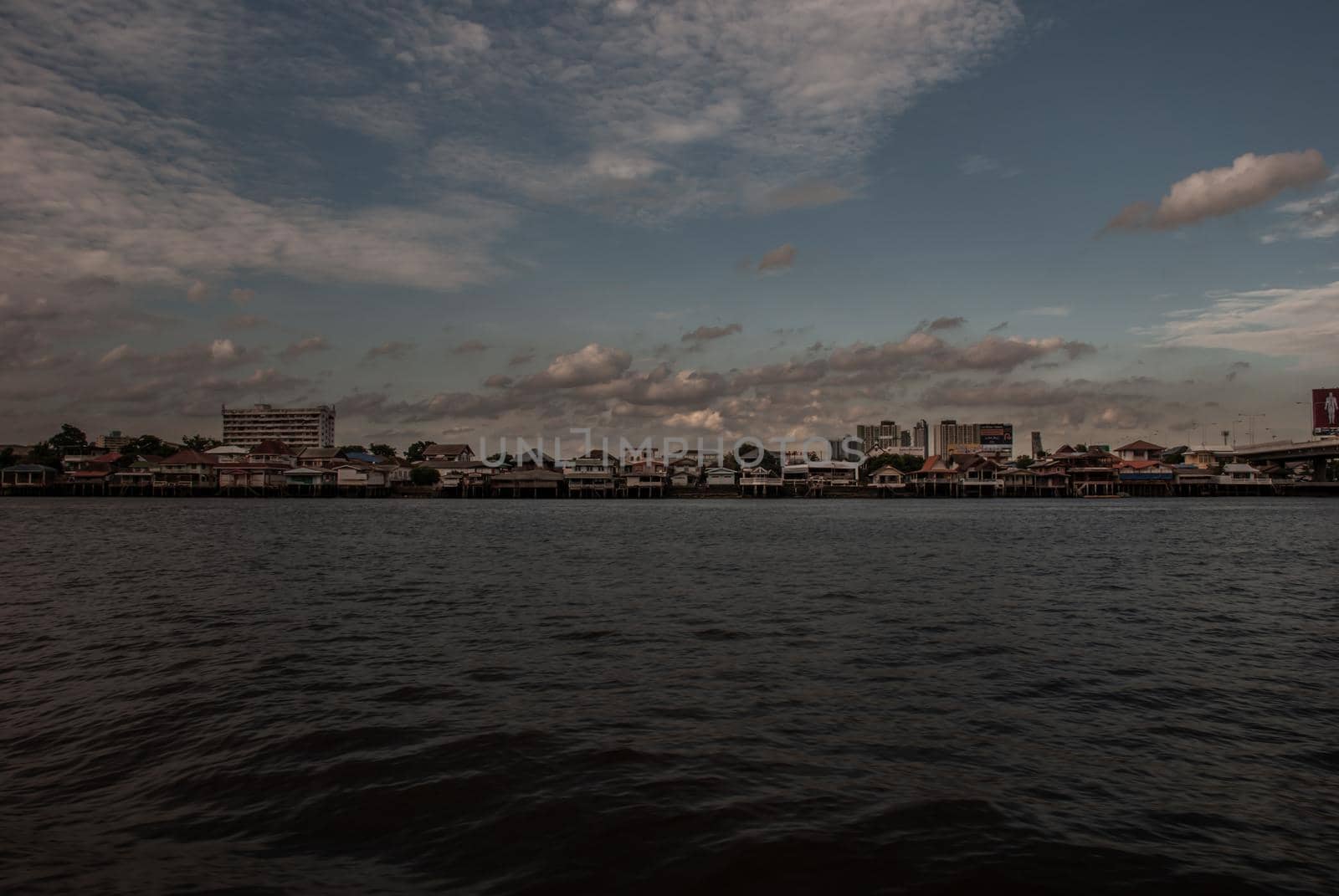 Bangkok, Thailand - 21 Jul 2019 : A view of the Chao Phraya River showing the several buildings in the evening along the Chao Phraya riverside in the beautiful skyline.