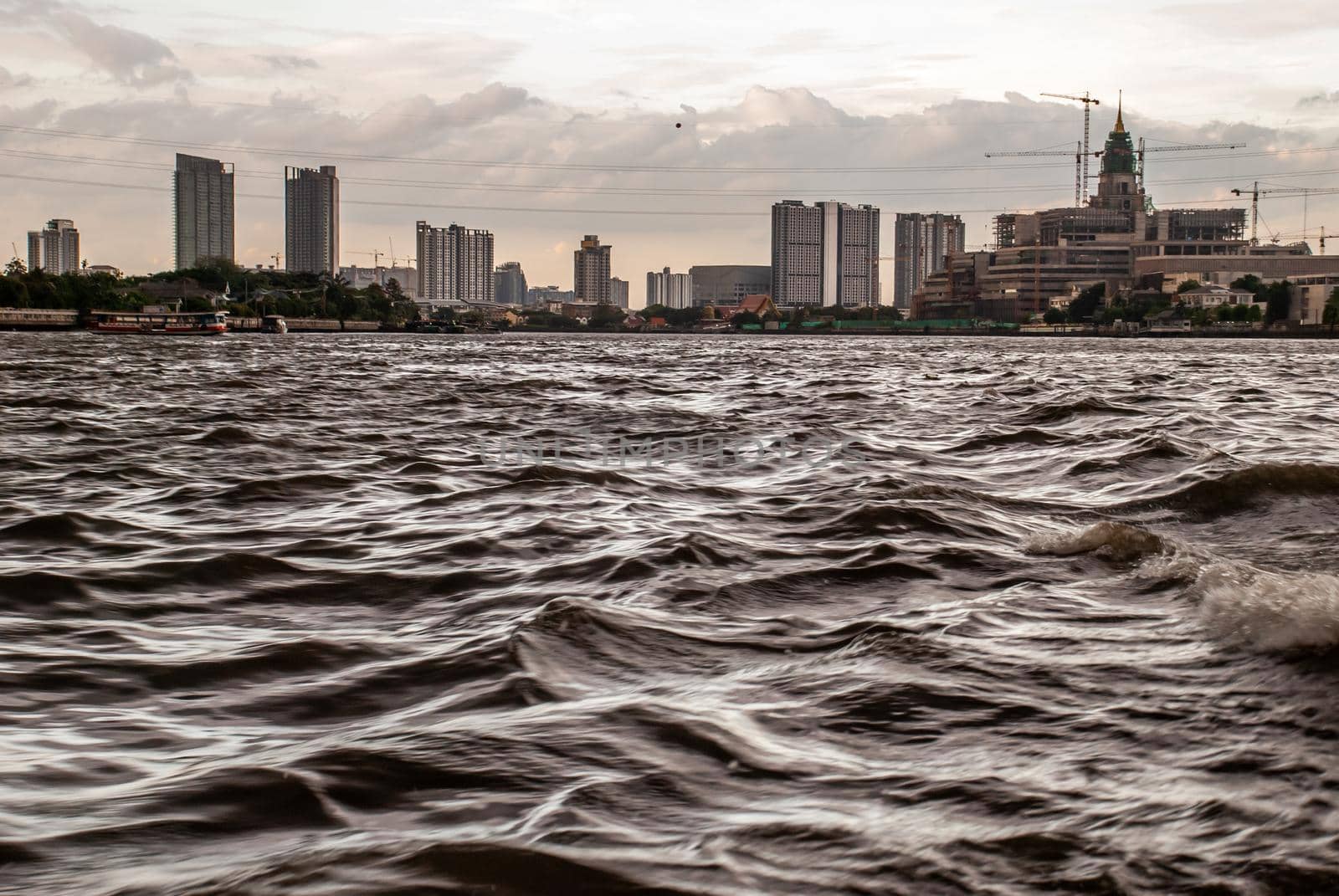 Bangkok, Thailand - 21 Jul 2019 : A view of the bank of Bangkok's Chao Phraya River showing the several tall buildings in the beautiful sky.