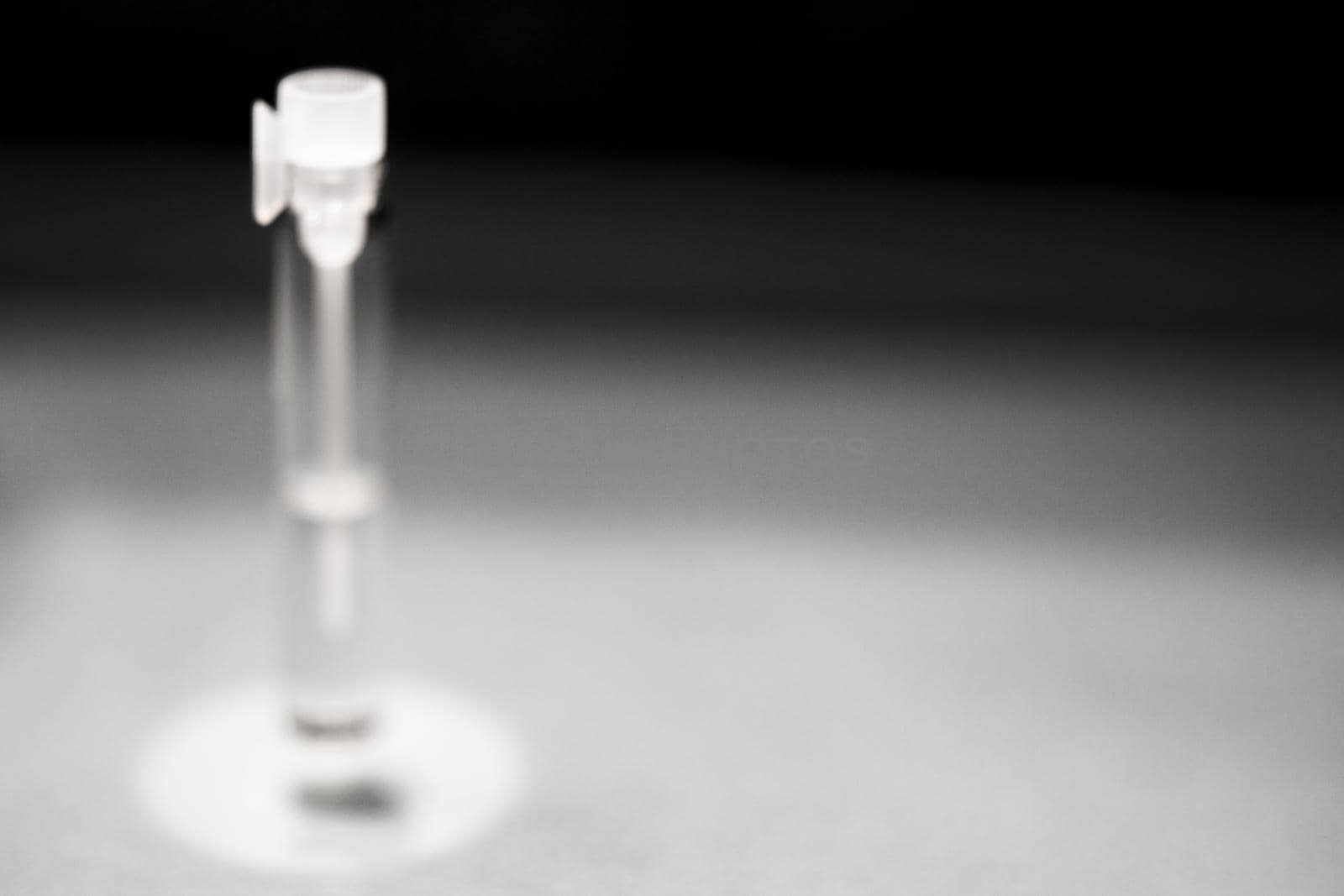 Glass bottle with perfume sample. No people. Copy space
