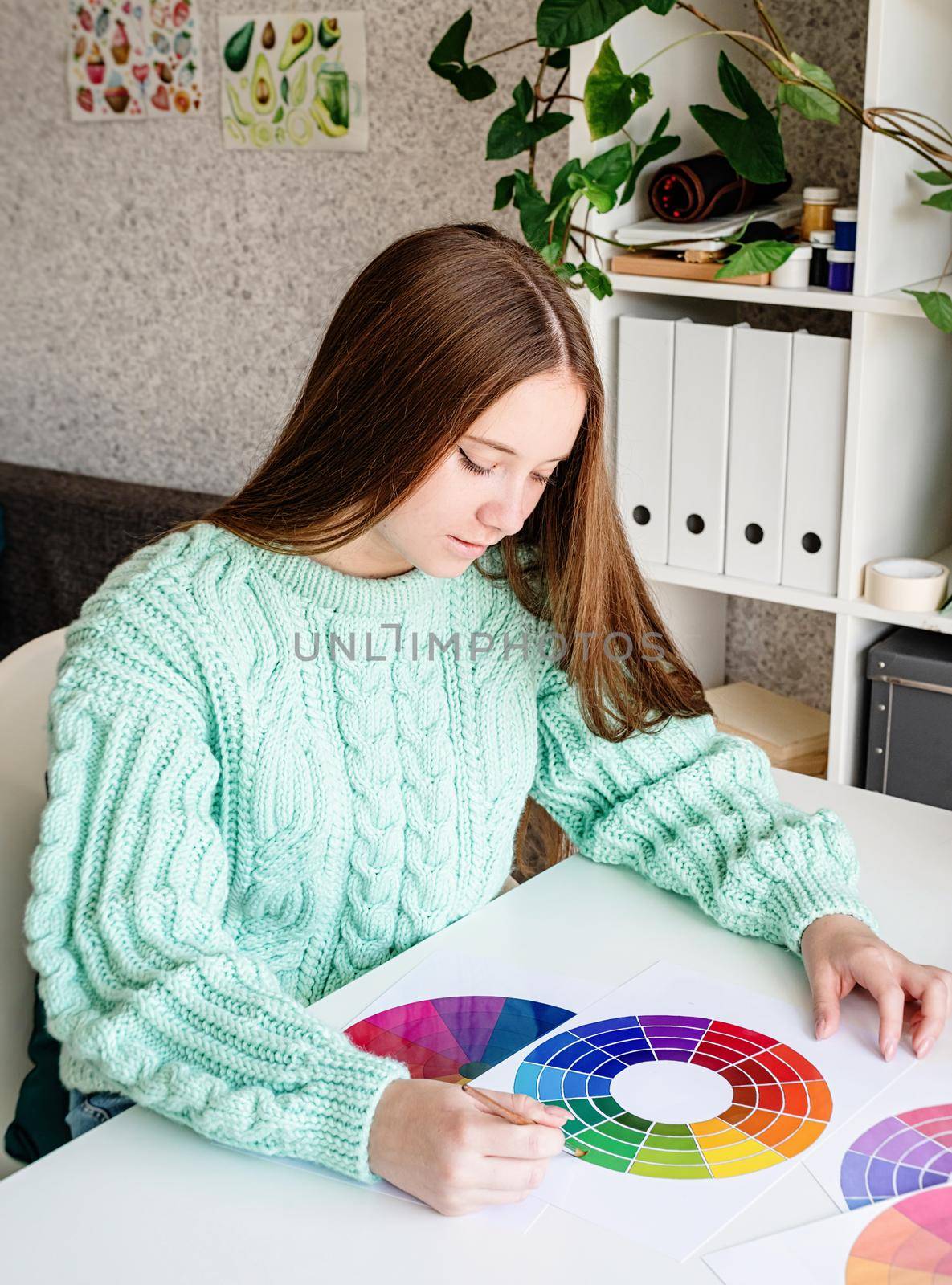 Artist or designer working with color wheel and color samples