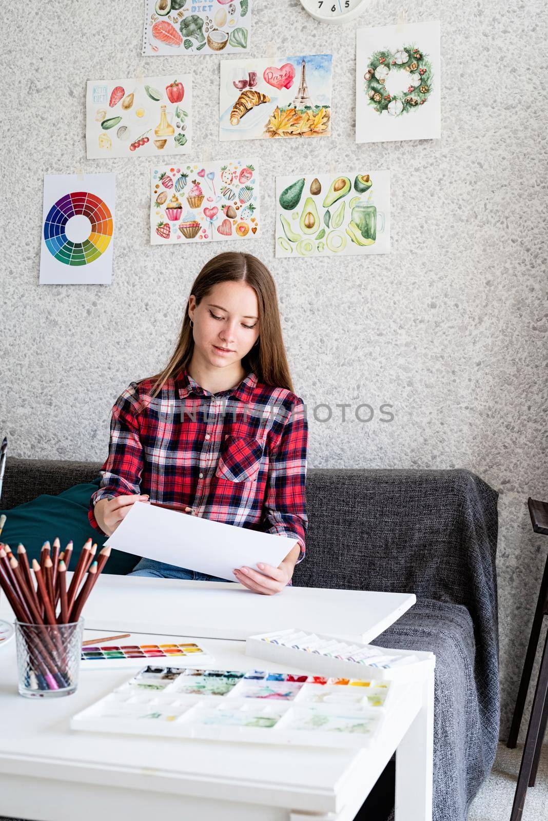 Beautiful woman artist painting a picture at home by Desperada
