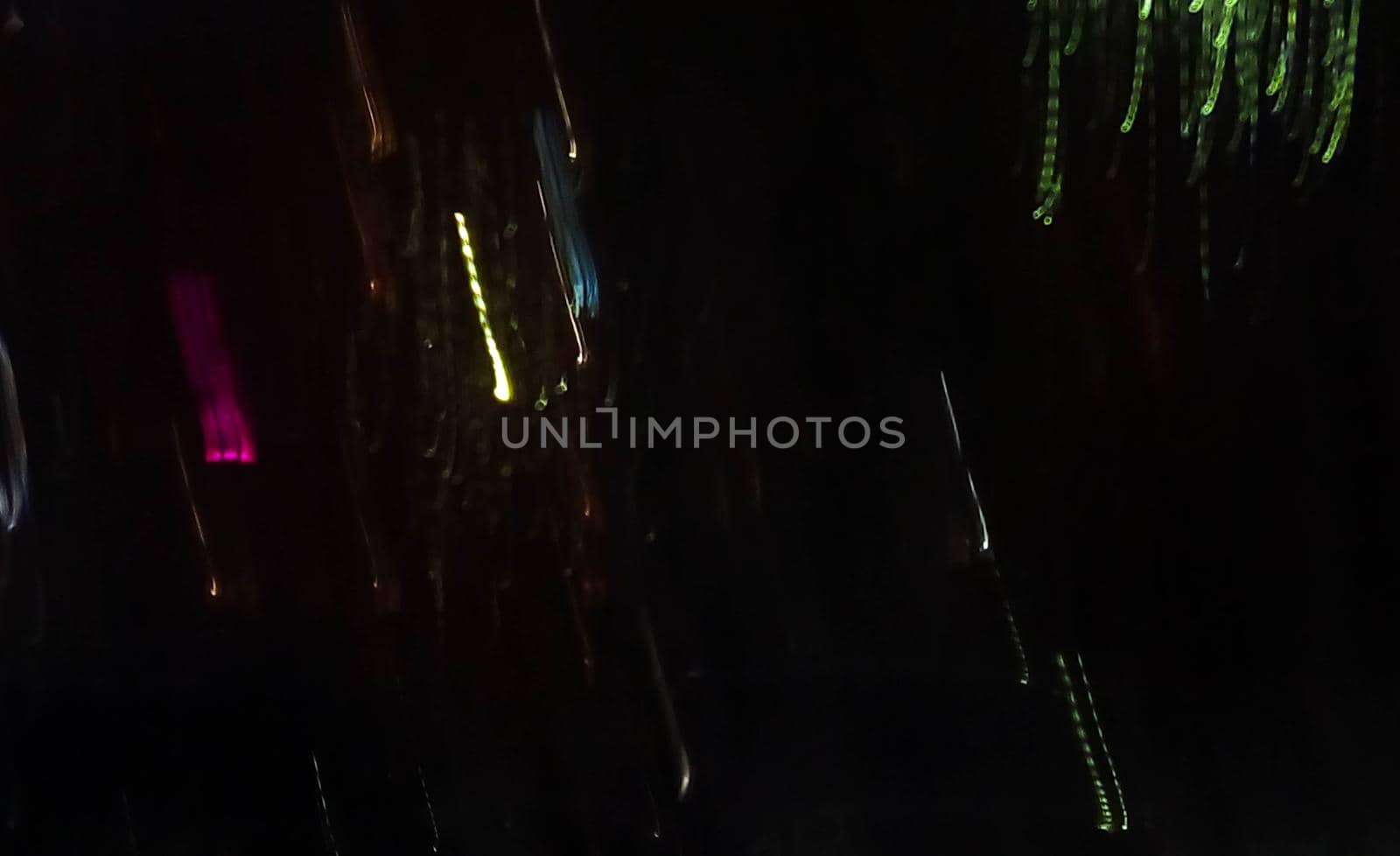 Reflection in a glass of glass. Blurred fires of distant houses. Window.