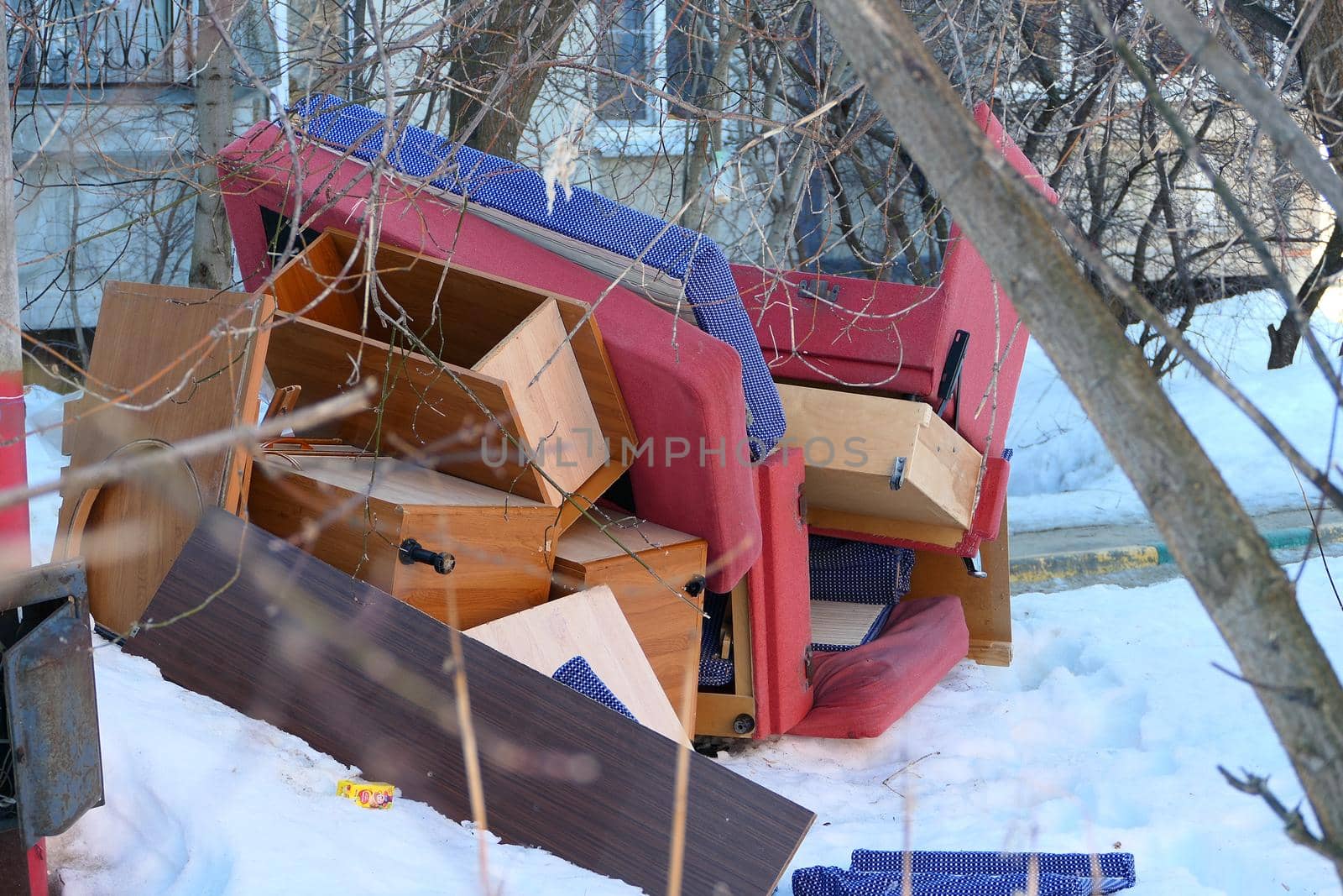 Old furniture thrown in the trash near the street trash cans. by Olga26