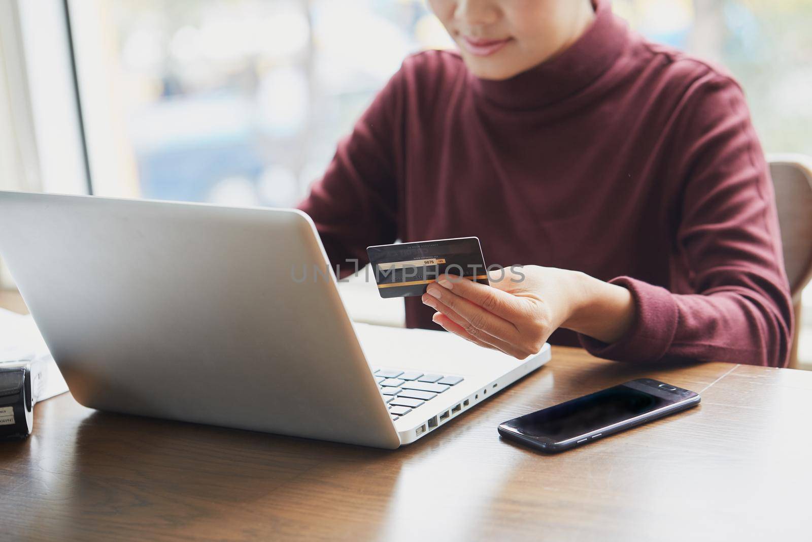 Close up of female hands making online payment with credit card