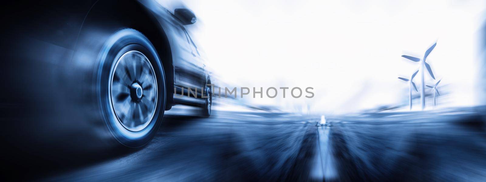 Speeding car is green power with copy space. Low angle side view of car driving fast on motion blur