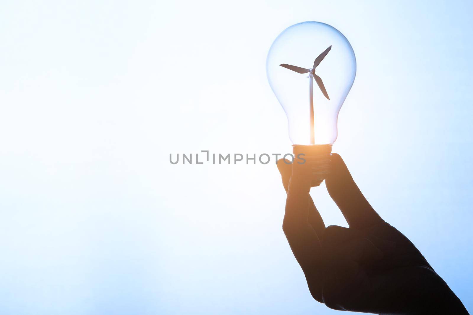 Electrical power from wind turbines. Idea in bulb. Clean power concept