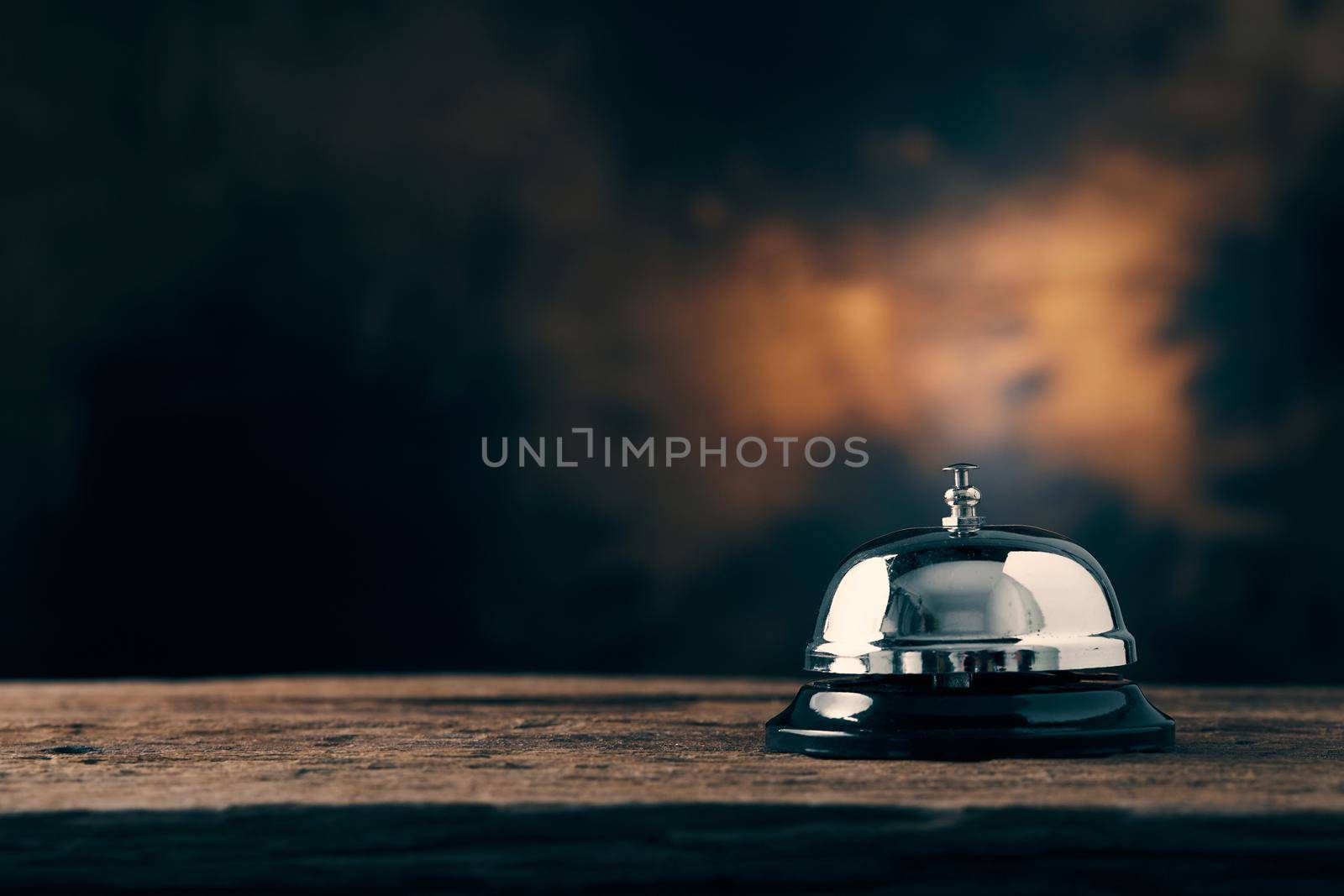 Bell of service on wood table with dark background