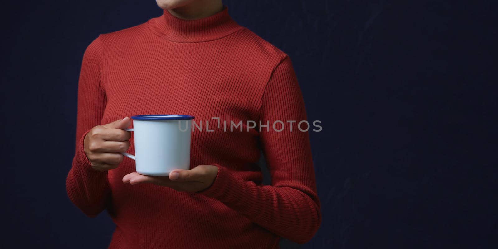 Women wearing fashion dresses is holding big cup on dark background