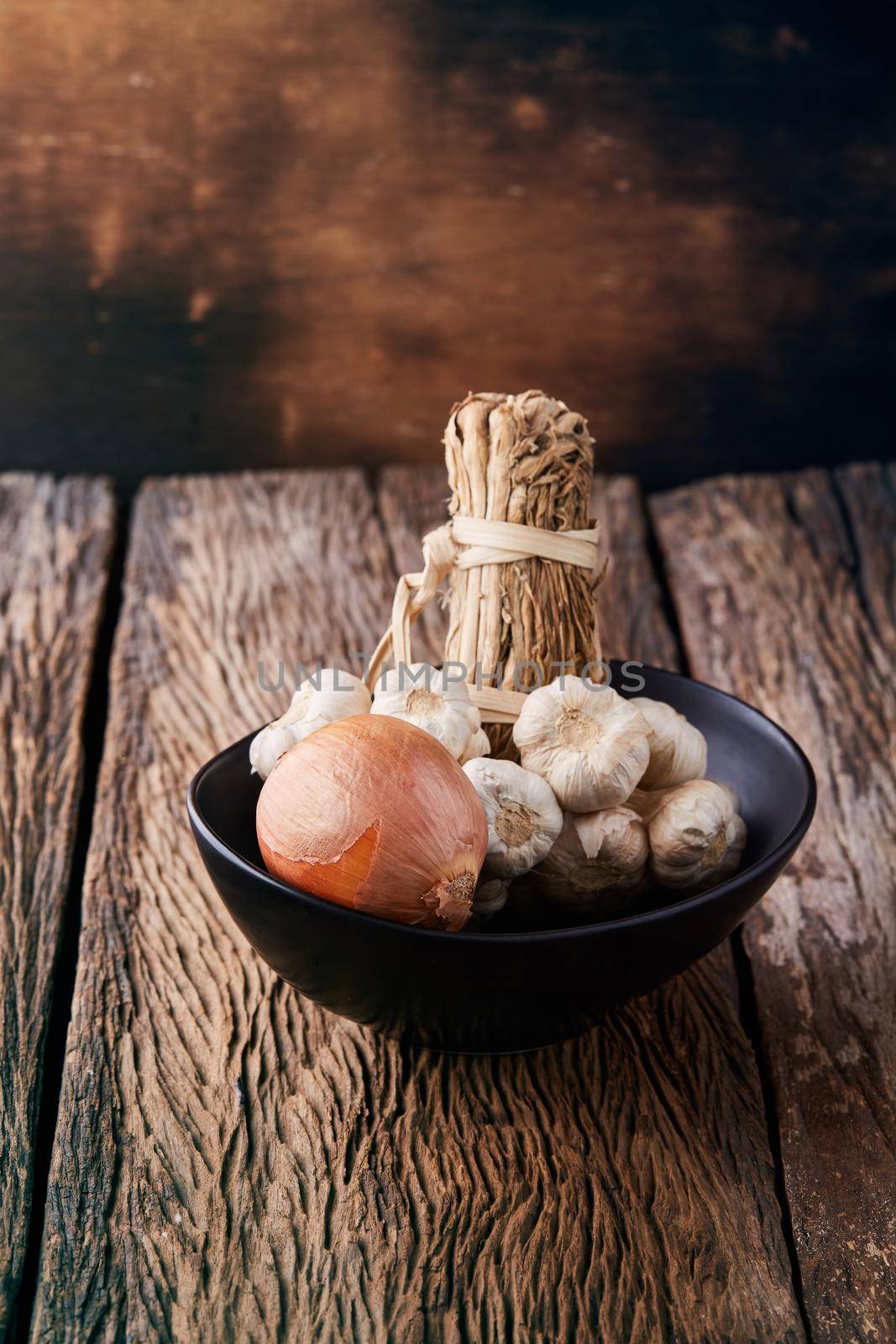 Still life with onions and garlics on wooden