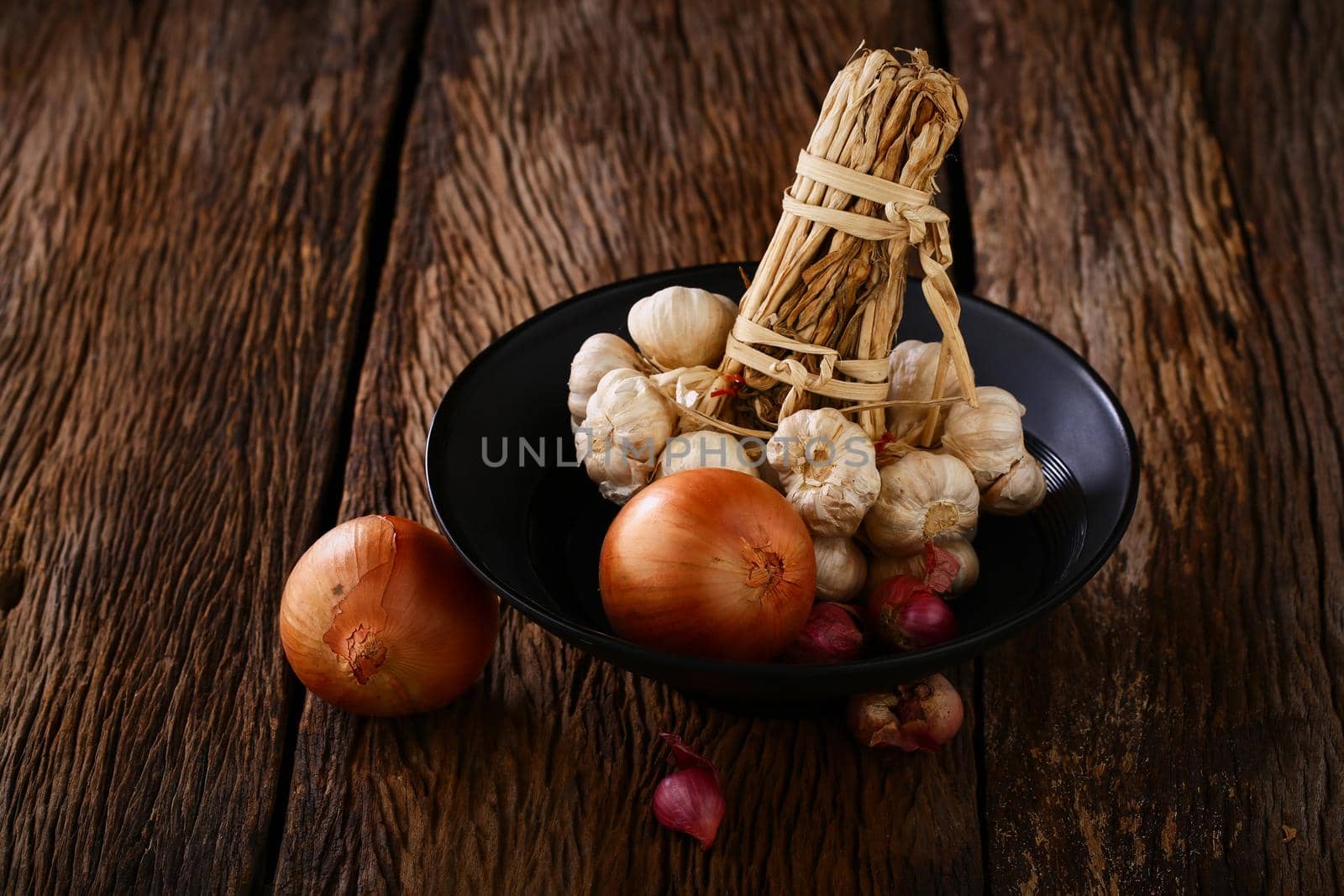 Still life with onions and garlics on wooden