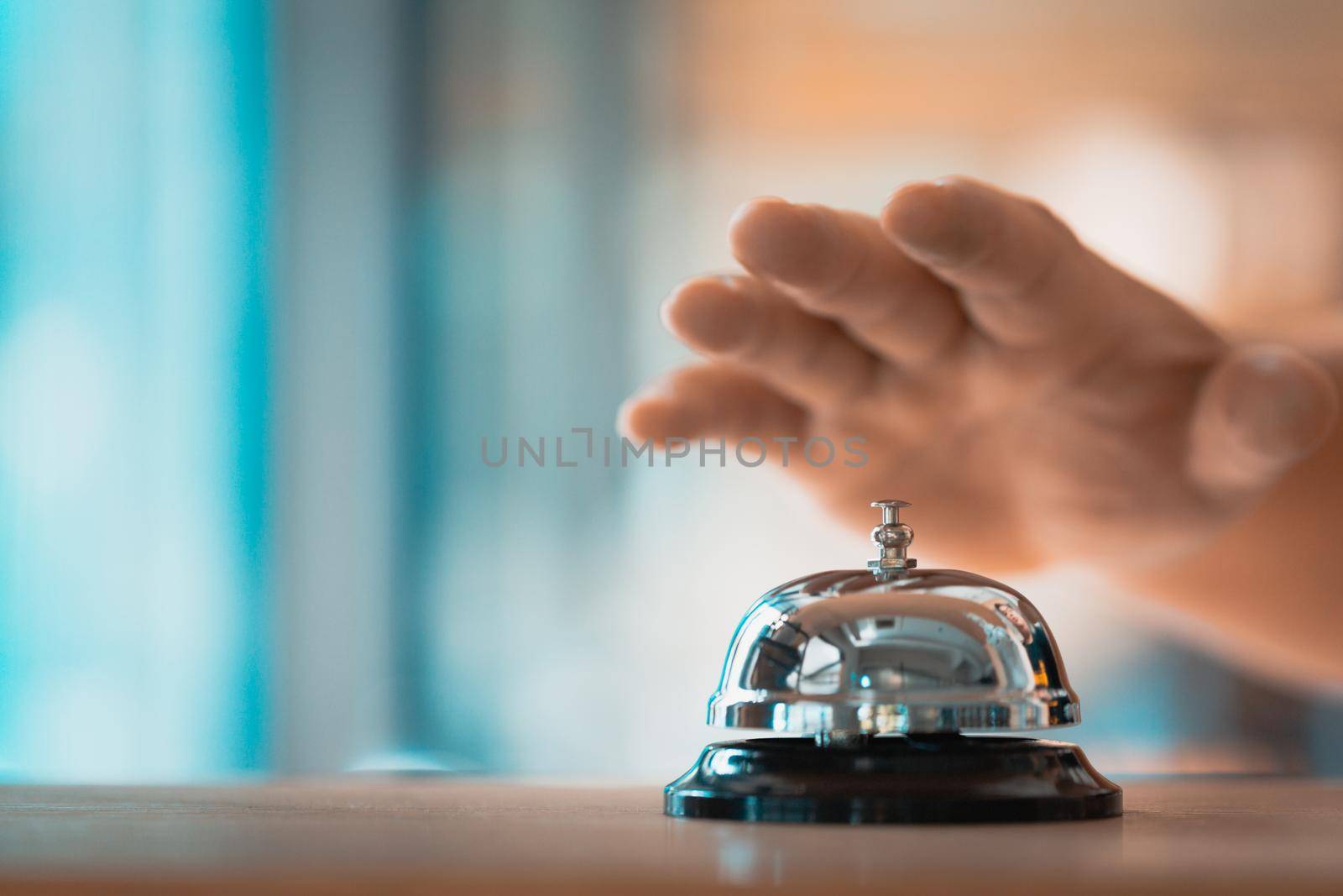 Bell on counter for service with hand. Ring the bell