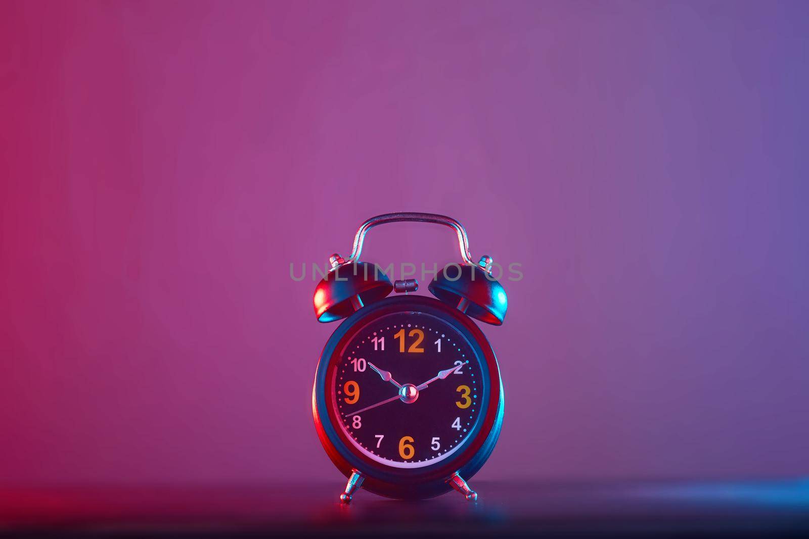 Alarm Clock colorful lighting. Take photo on studio