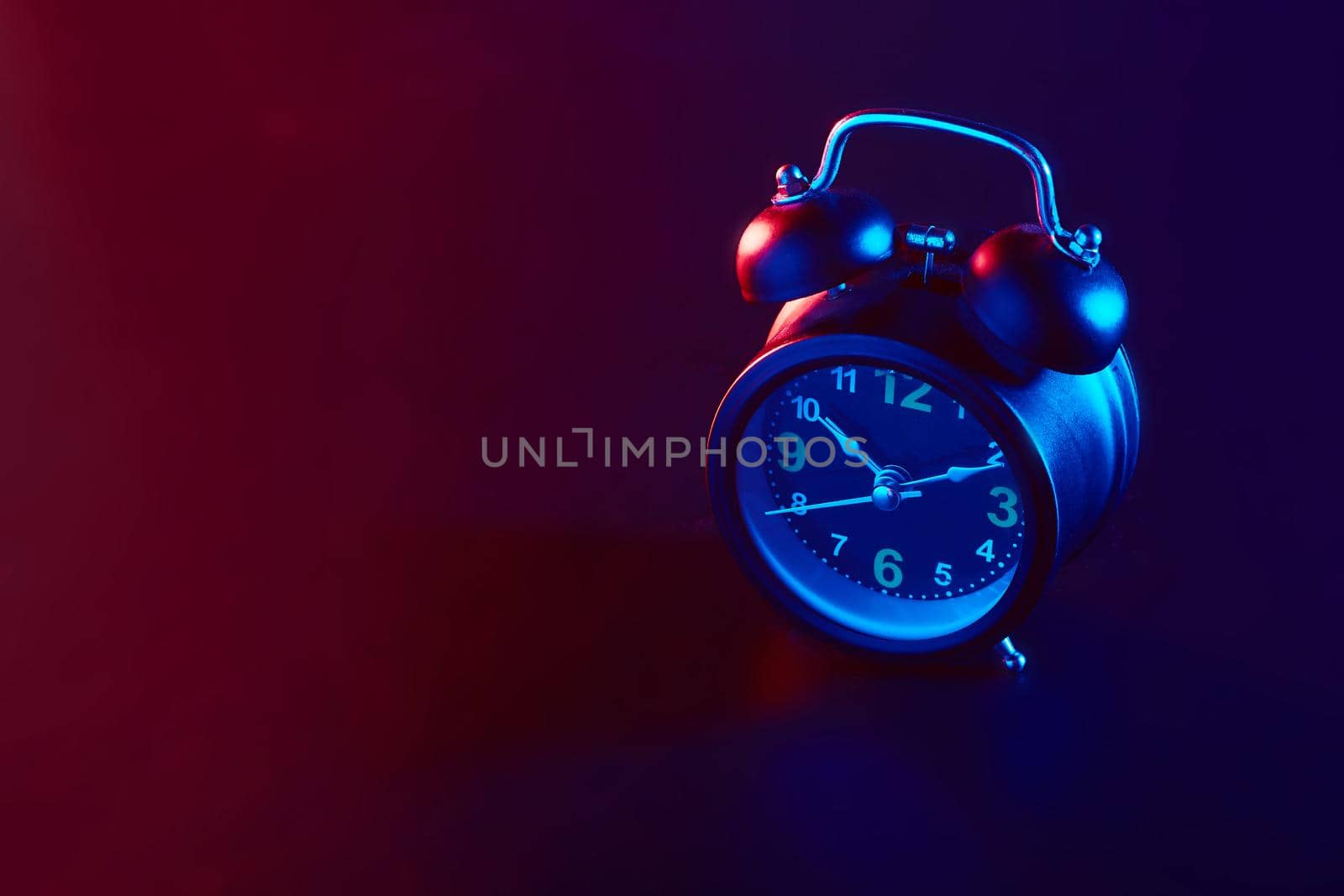 Alarm Clock colorful lighting. Take photo on studio