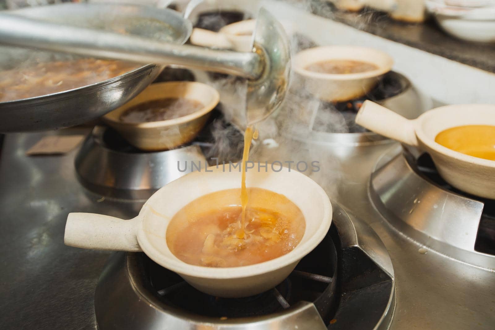 Boiling shark's fin soup. Traditional luxury menu of Chinese