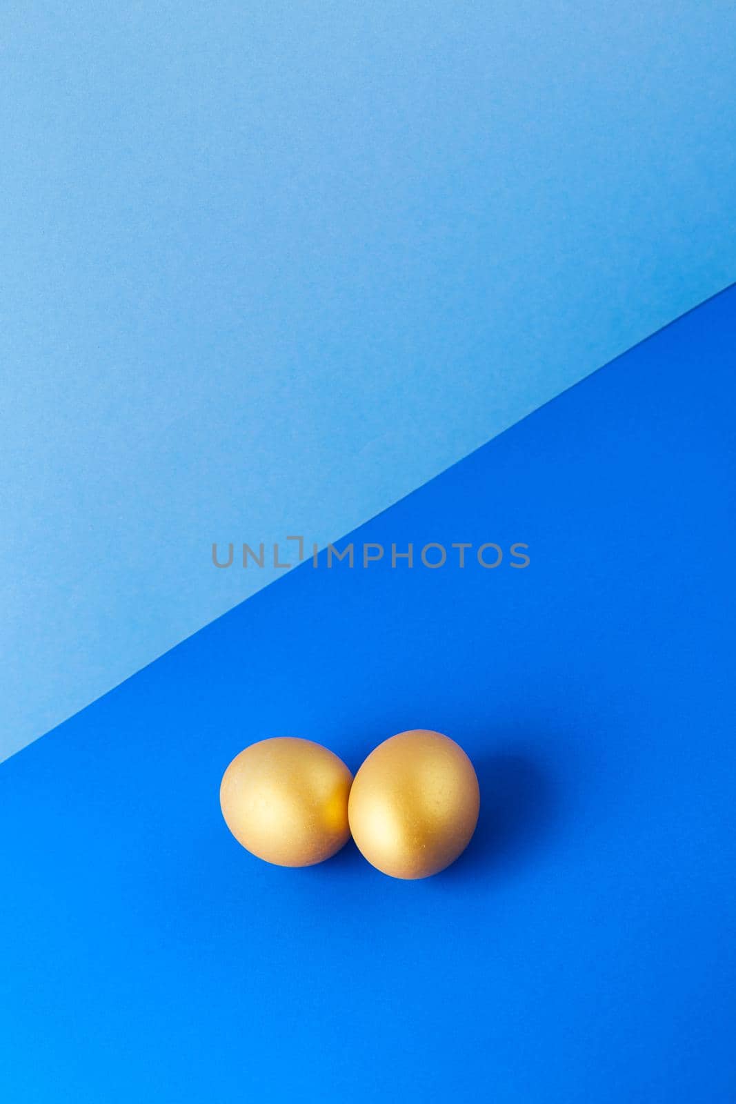 Couple Eggs Easter golden on blue background